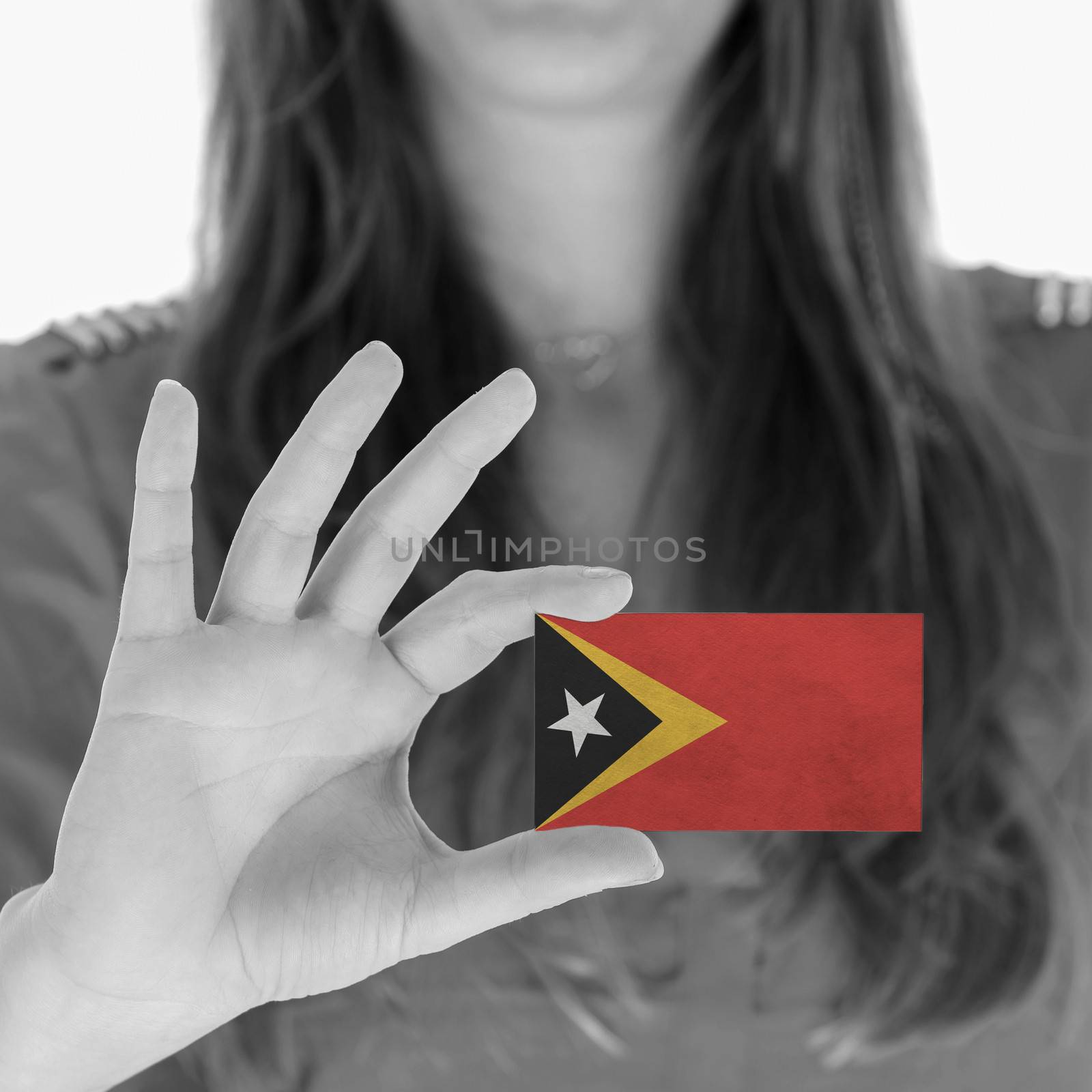 Woman showing a business card, flag of East Timor