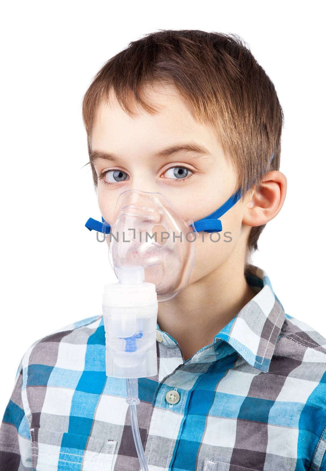 Portrait of cute boy using nebulizer on white background