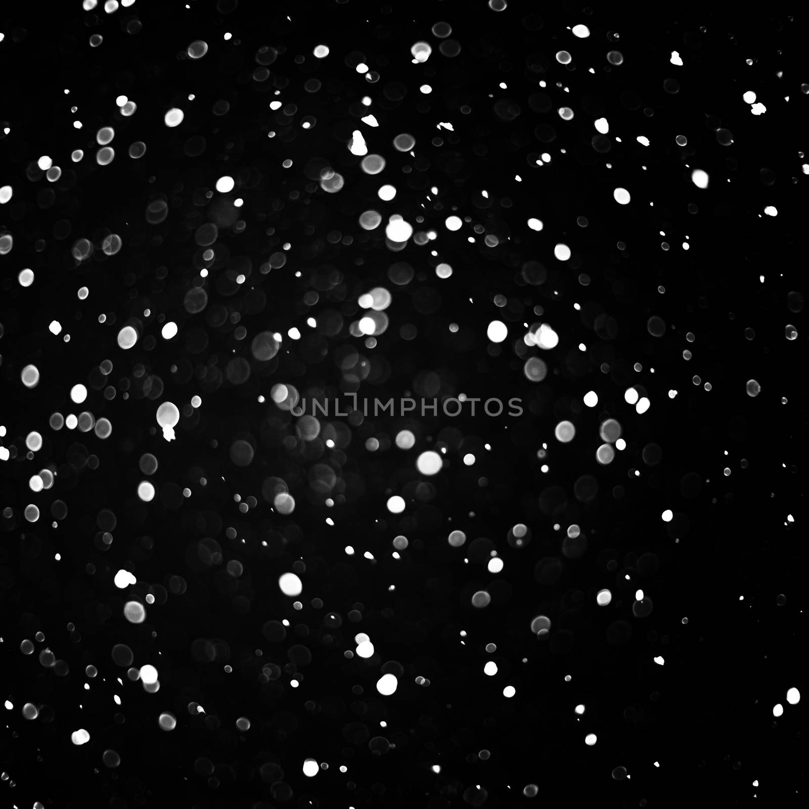 Falling snow background - snowflakes over night dark sky