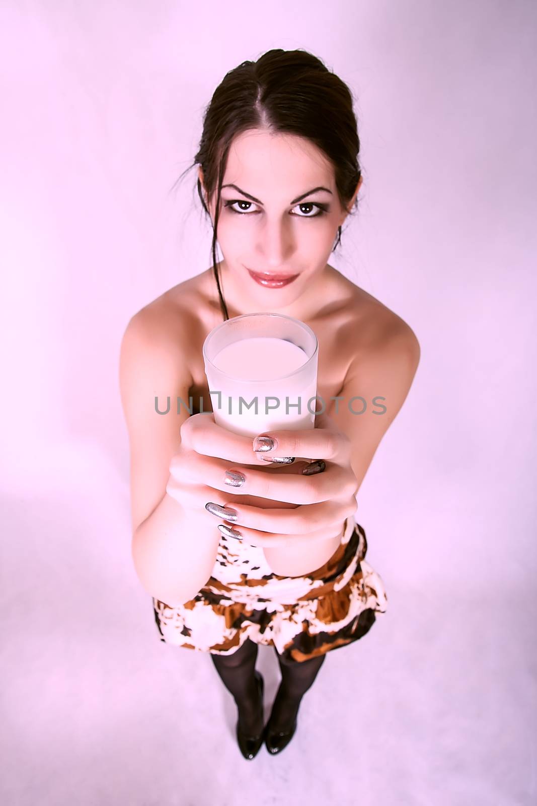 portrait of happy and smiling beautiful young woman enjoying a glass milk