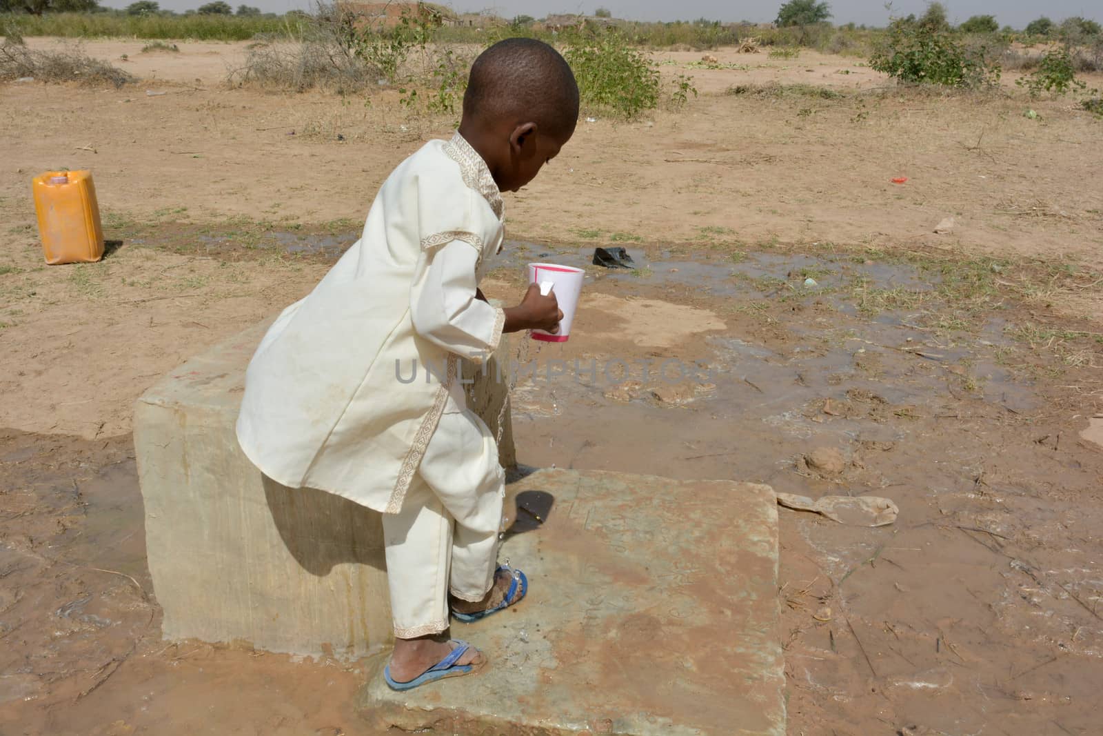 African child drinks water