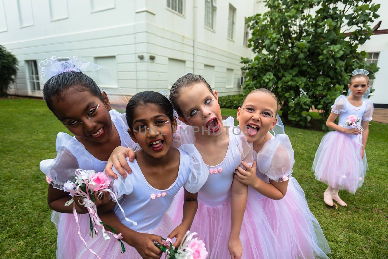 Ballet Gala of young pr teen girls outside playing posing funny faces before performance on stage.