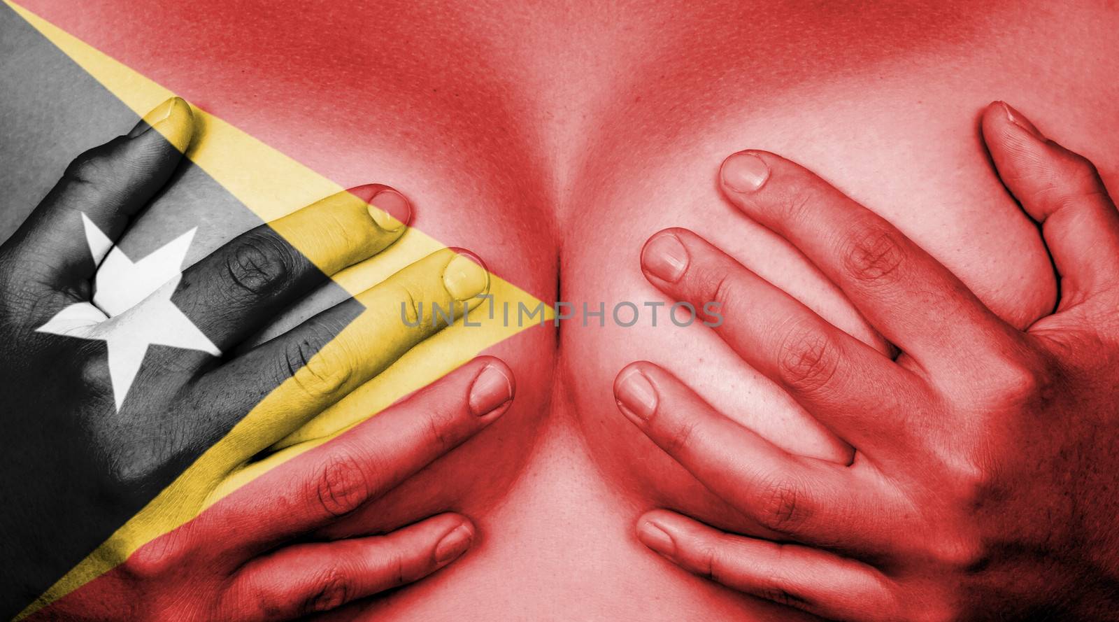 Upper part of female body, hands covering breasts, flag of East Timor