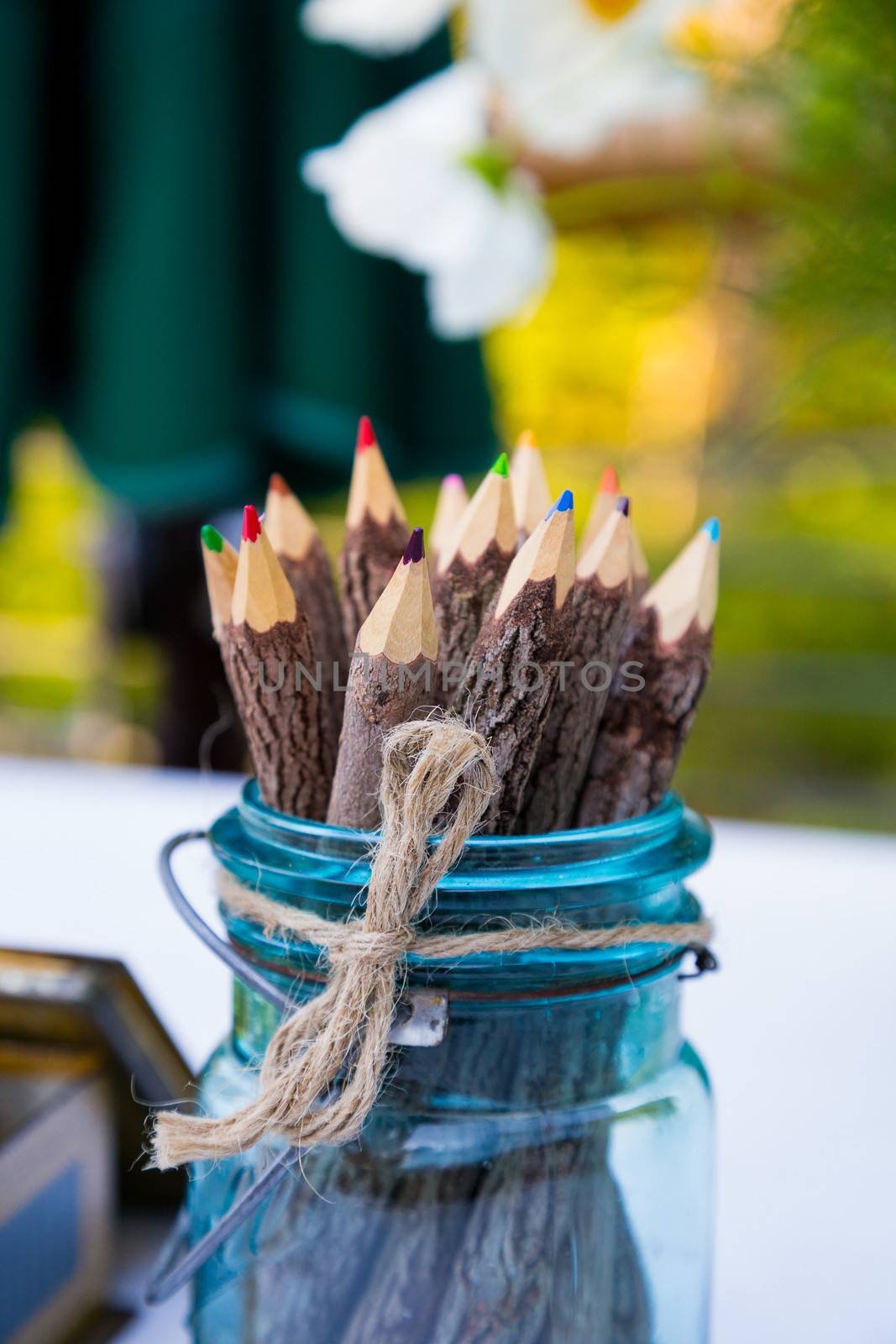 These color pencils are in a blue jar at a wedding for the guests to use to write or draw.