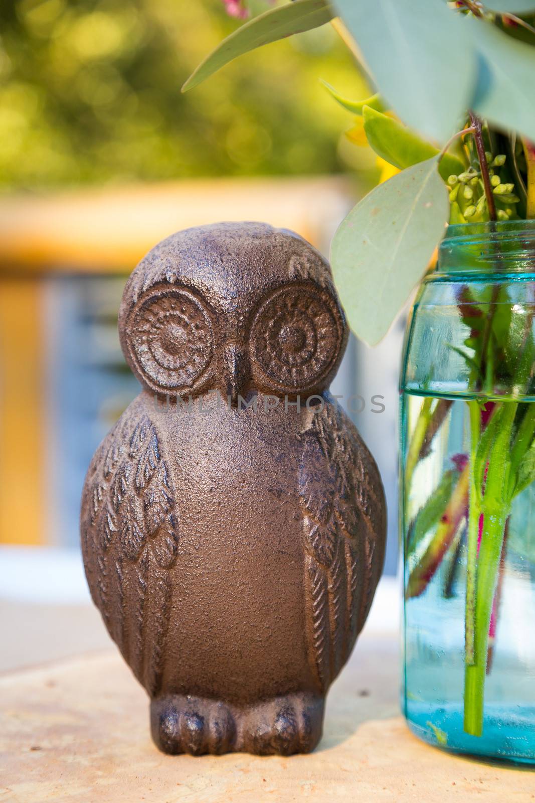 Centerpieces for this wedding include handmade wooden owls and flowers on the reception tables.