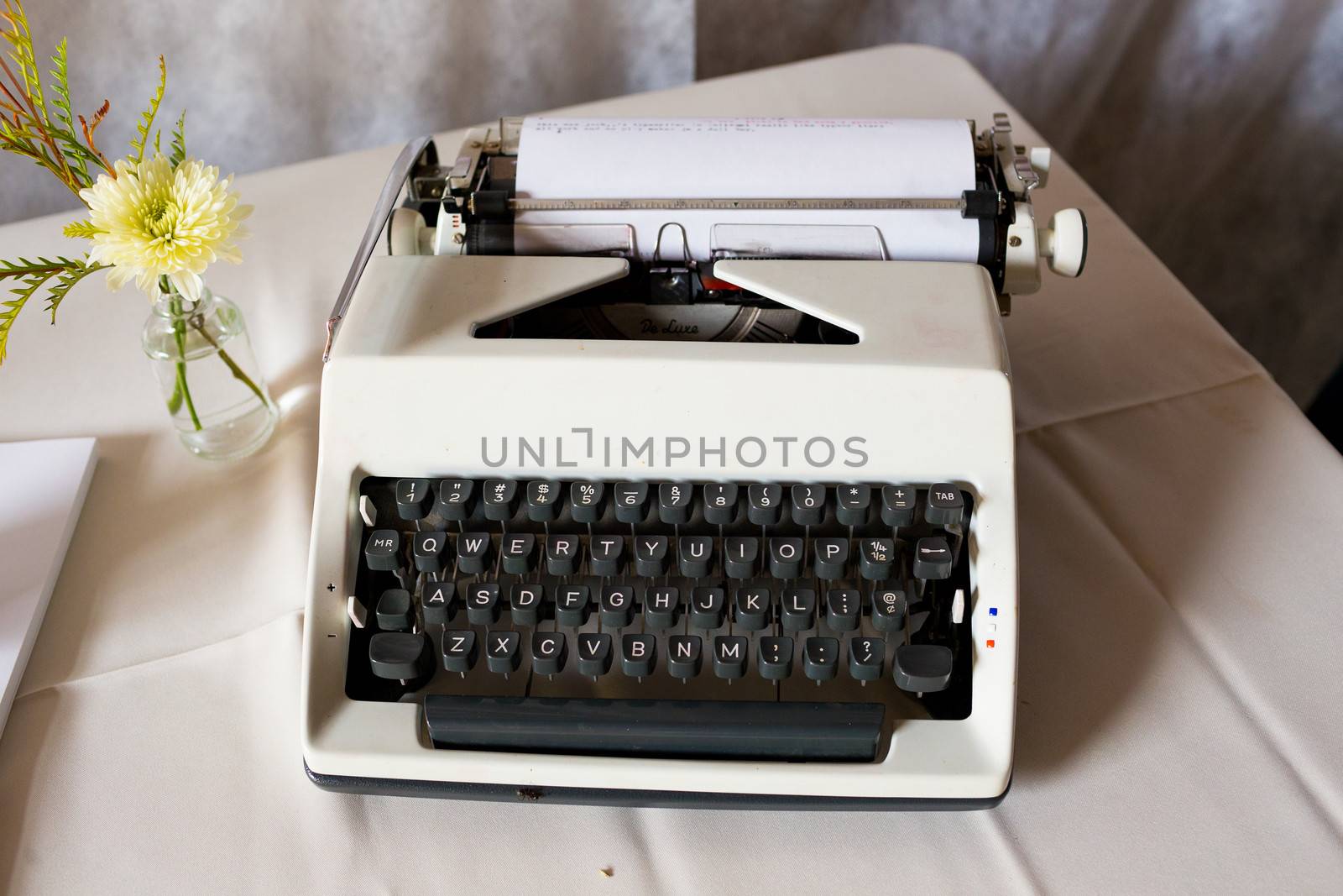 An antique typewriter is used as a guestbook at this wedding ceremony and reception.
