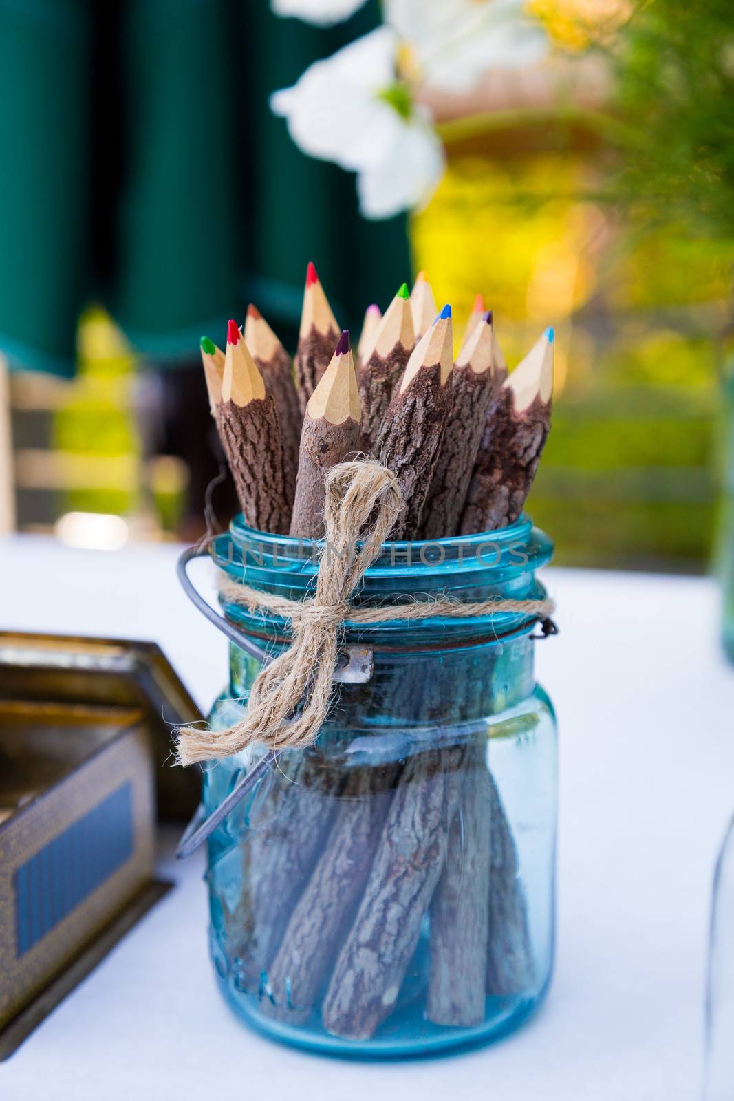 These color pencils are in a blue jar at a wedding for the guests to use to write or draw.