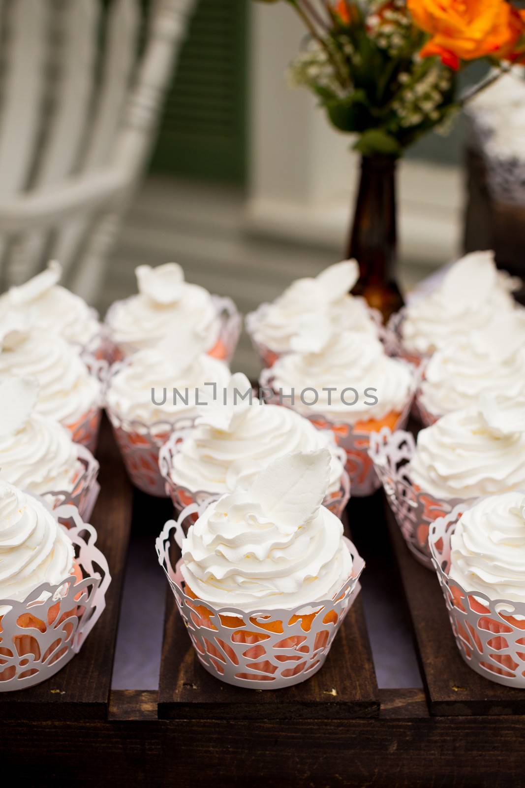 These cupcakes at a wedding reception are ready for the guests to enjoy after the cake cutting ceremony.