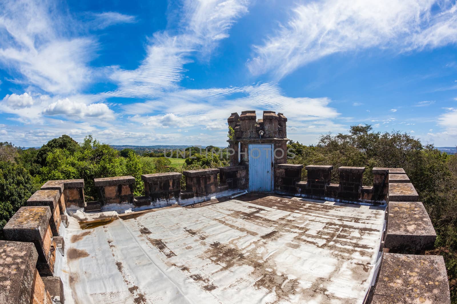 Rooftop view of small castle and surrounding trees green vegetation in nature park reserve at Stainbank Castle in Durban South-Africa