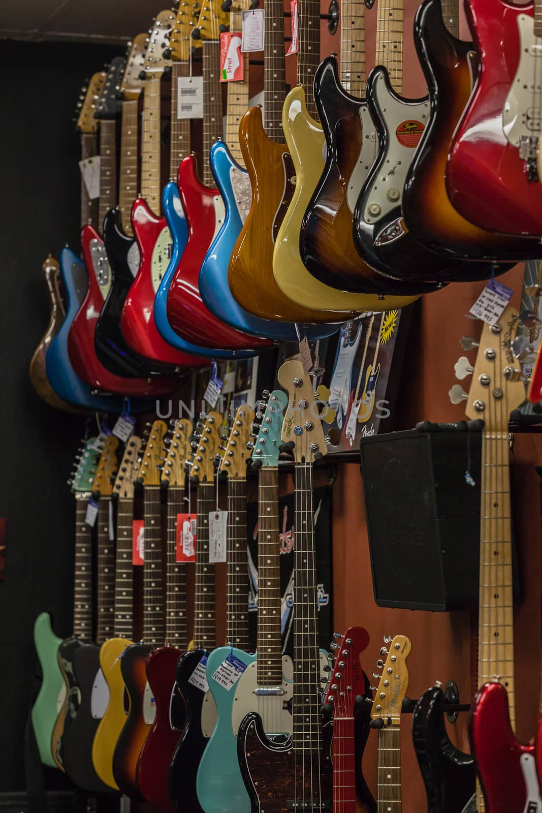 Music electric guitars instruments for sale in music shop display.