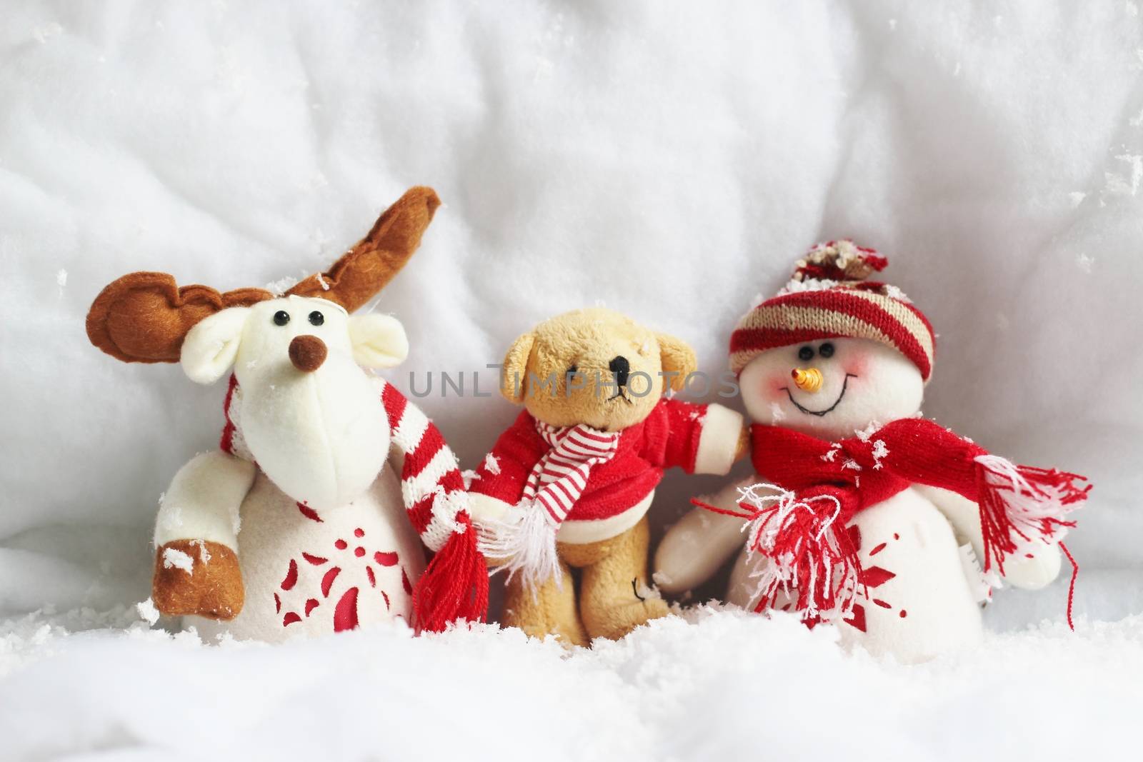 three christmas toys in snow