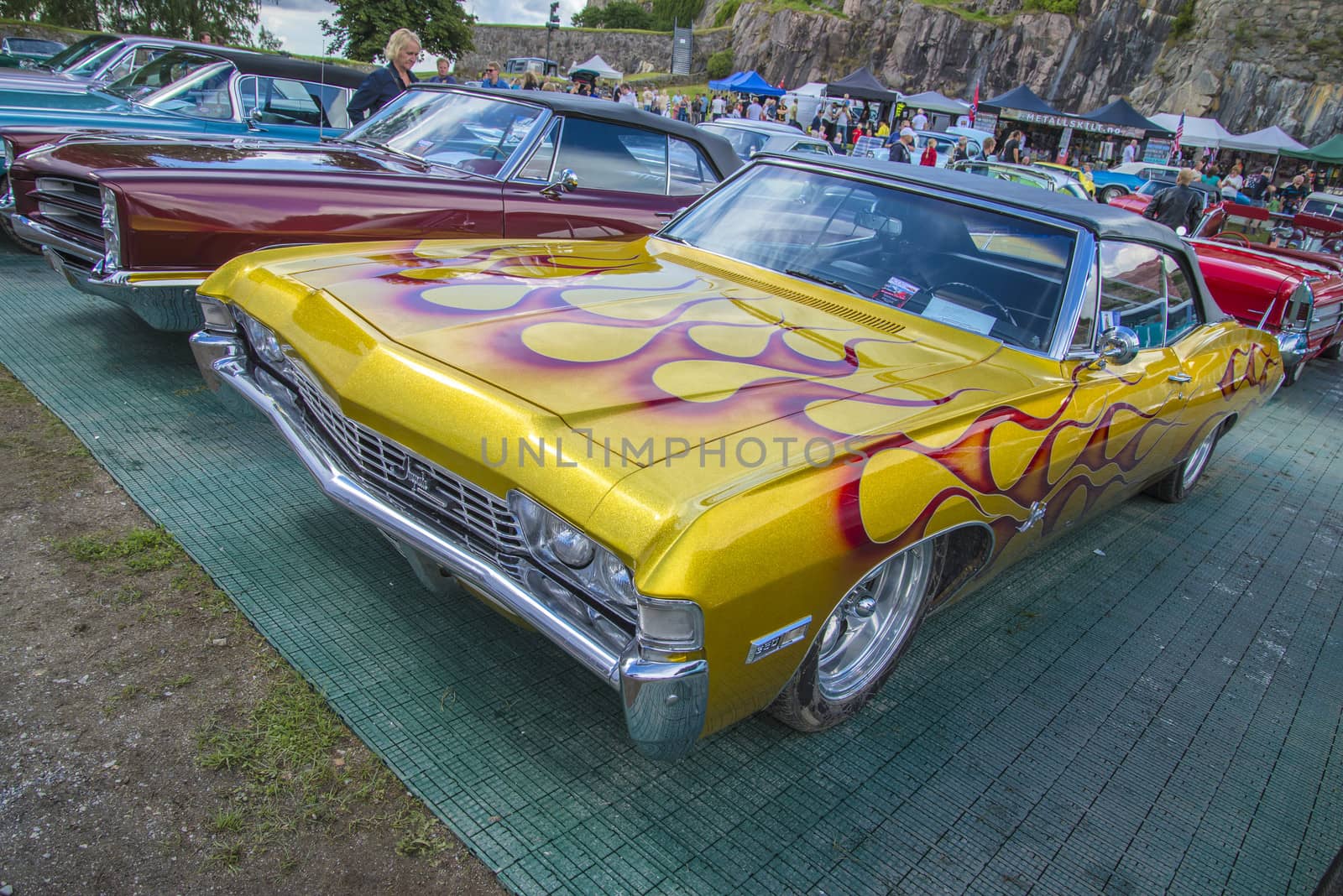 The image is shot at Fredriksten fortress in Halden, Norway during the annual classic car event.