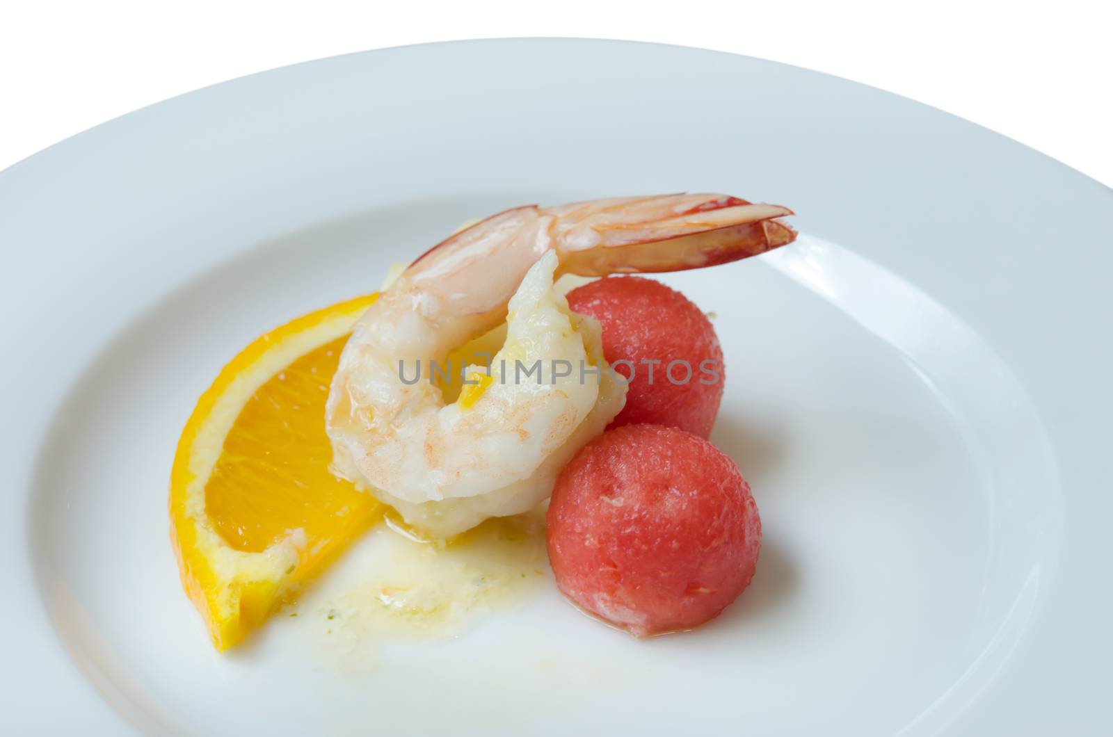 close up boiled shrimp , slices of orange and watermelon on dish over white background