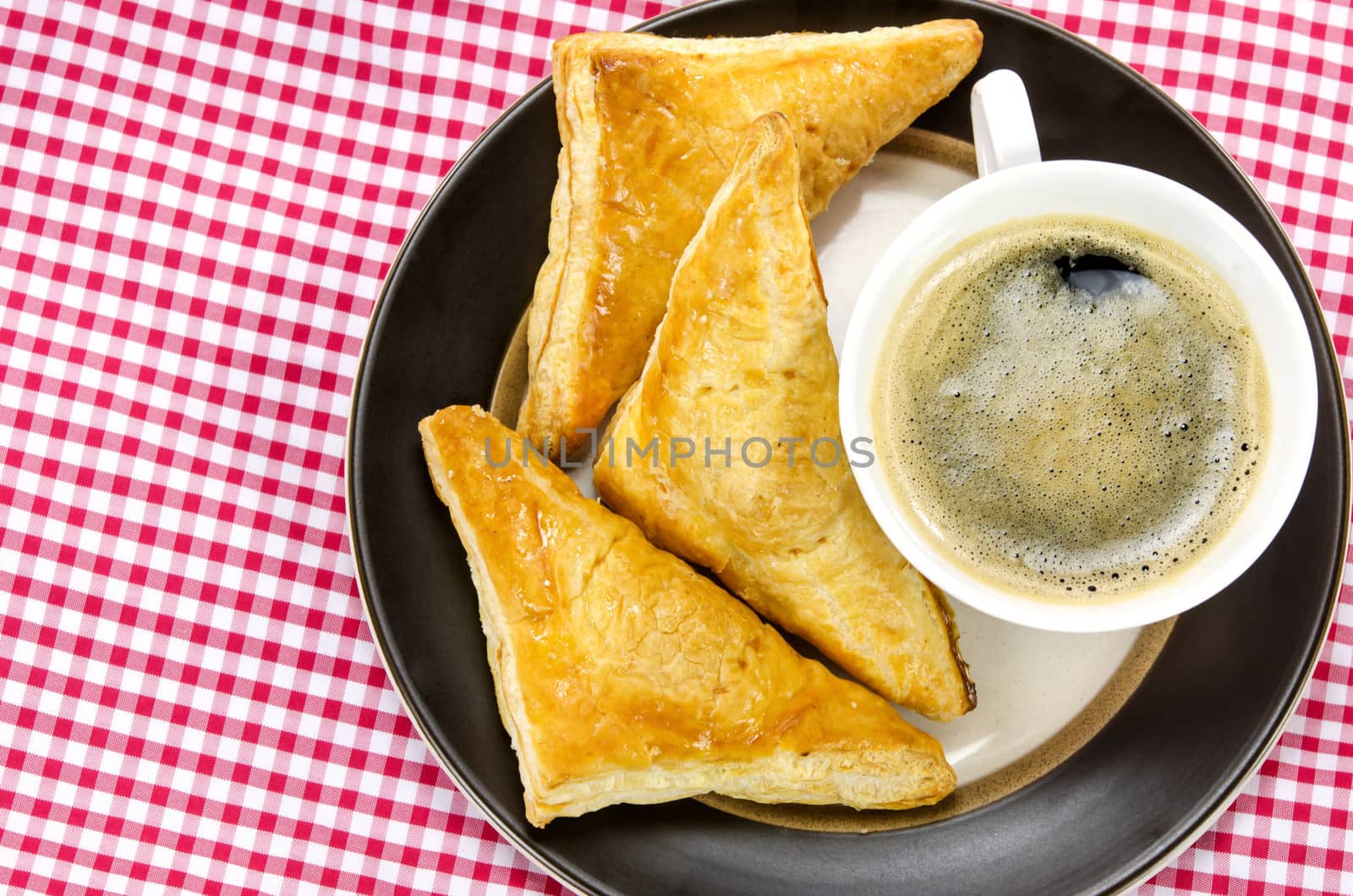 hot coffee in white cup  and puff pastry  on dish 
