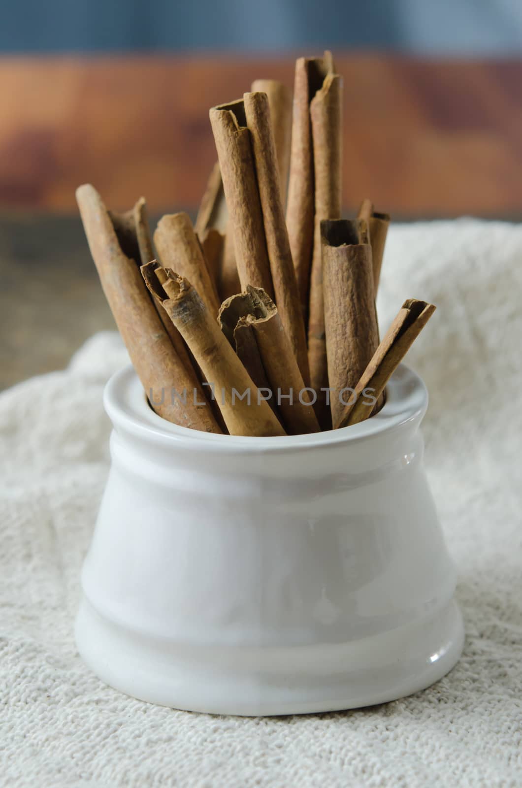 White  bowl with cinnamon sticks on  sackcloth