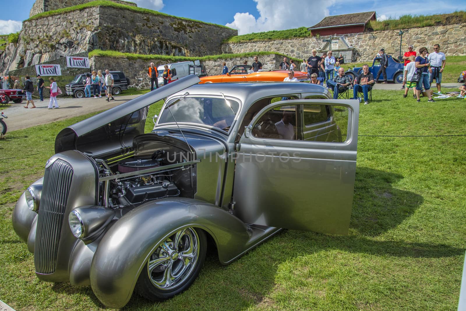 The image is shot at Fredriksten fortress in Halden, Norway during the annual classic car event.