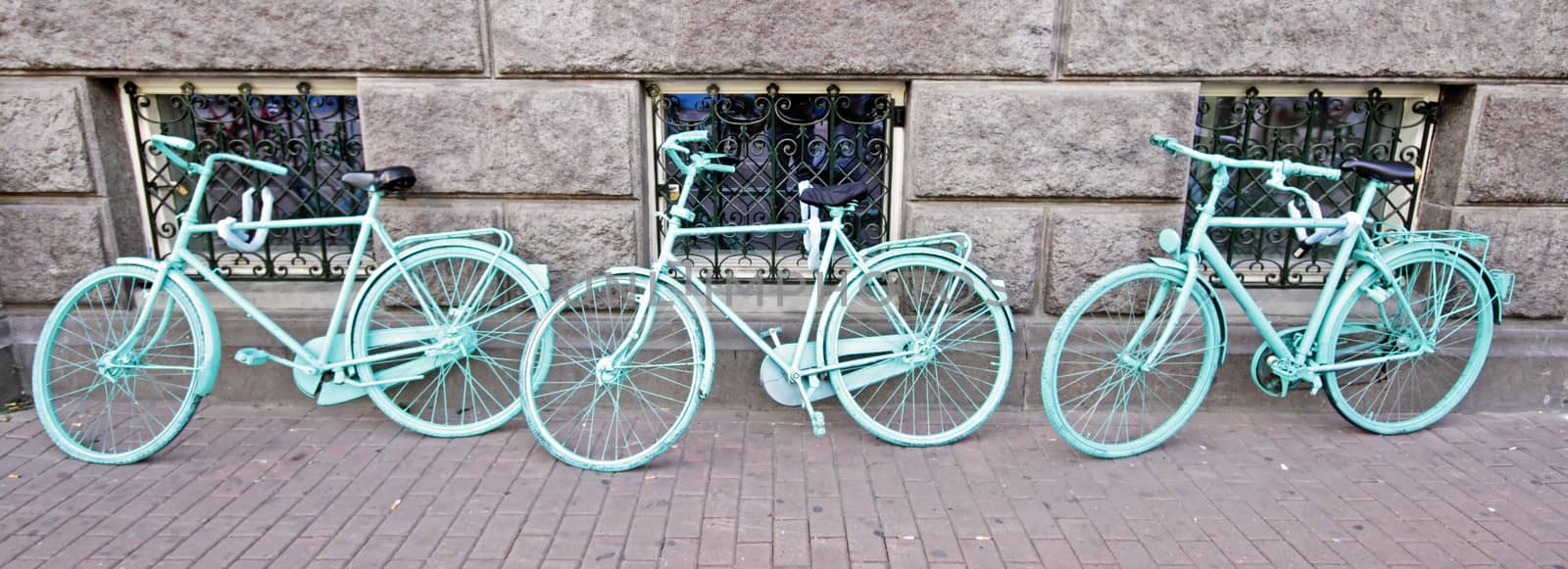 Three green bicycles against a wall in Amsterdam Netherlands by devy