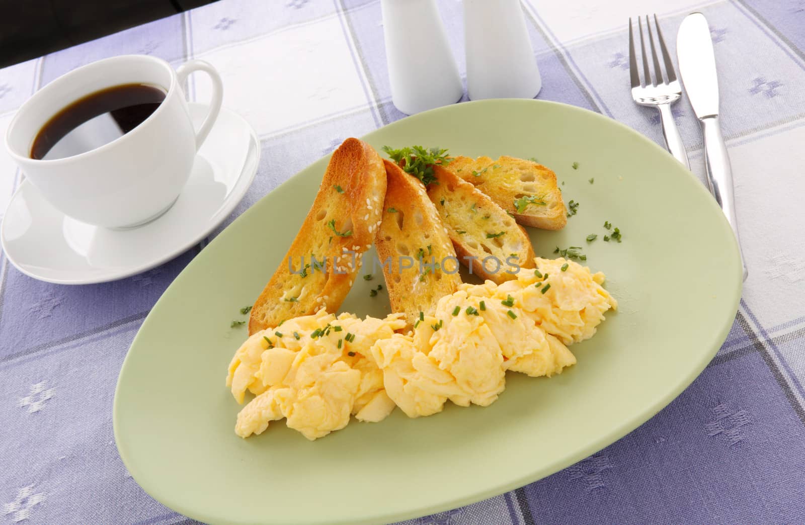 Delicious and healthy breakfast of scrambled eggs with toast.