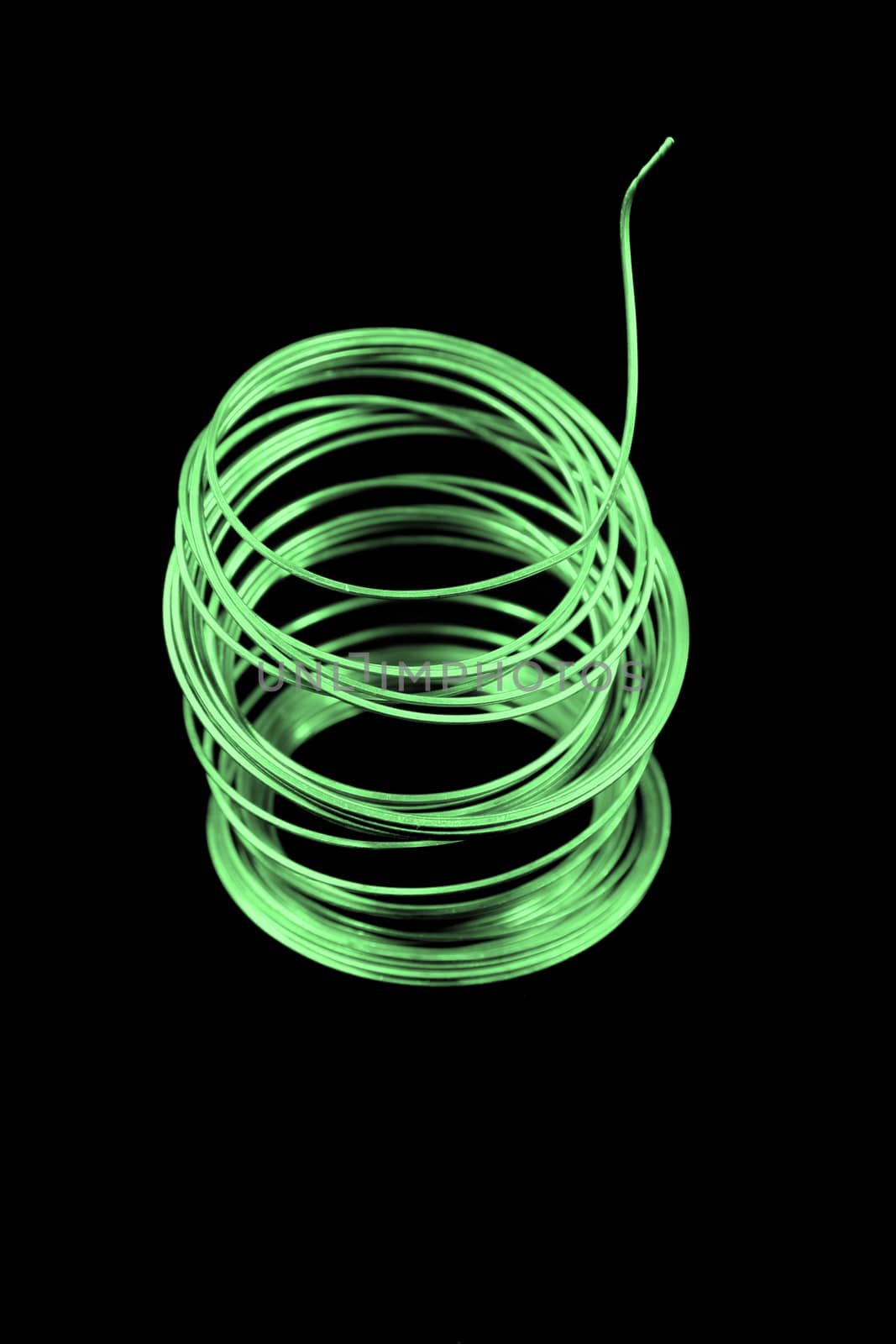 Roll of fuse wire with a green tint.