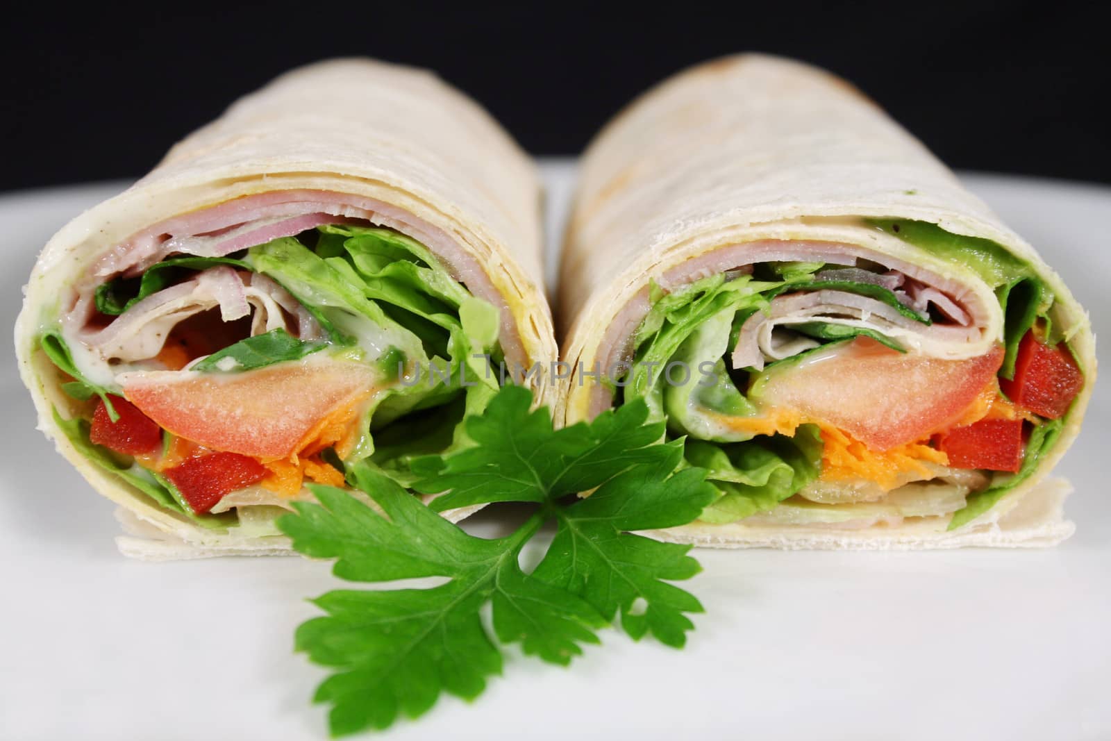 Delicious cut ham and salad wrap ready to serve.