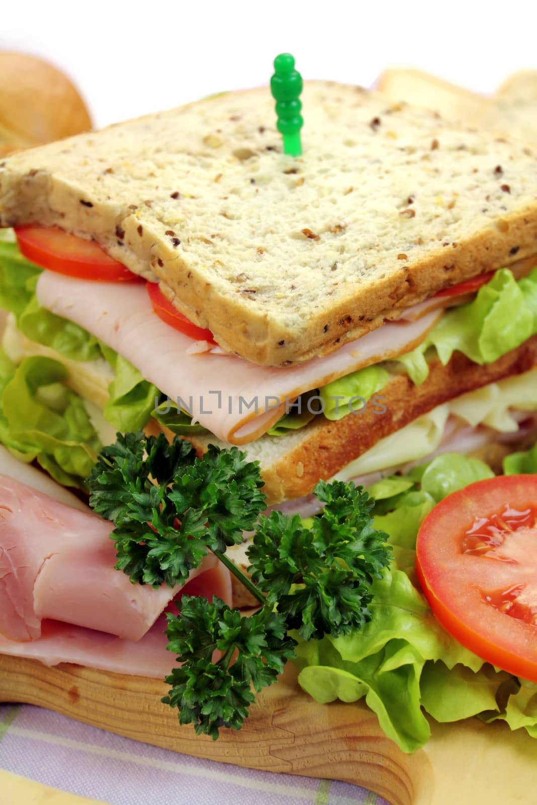 Delicious ham and salad sandwich with ingredients ready to serve.