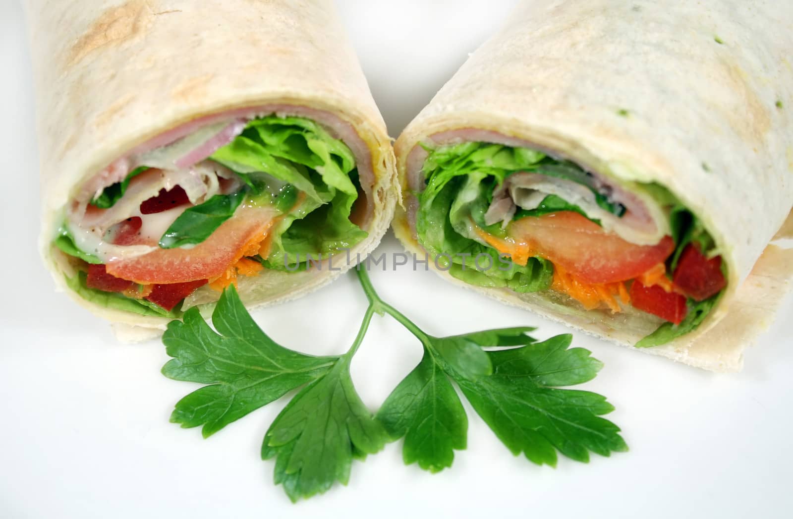 Freshly prepared ham and salad wrap ready to eat.