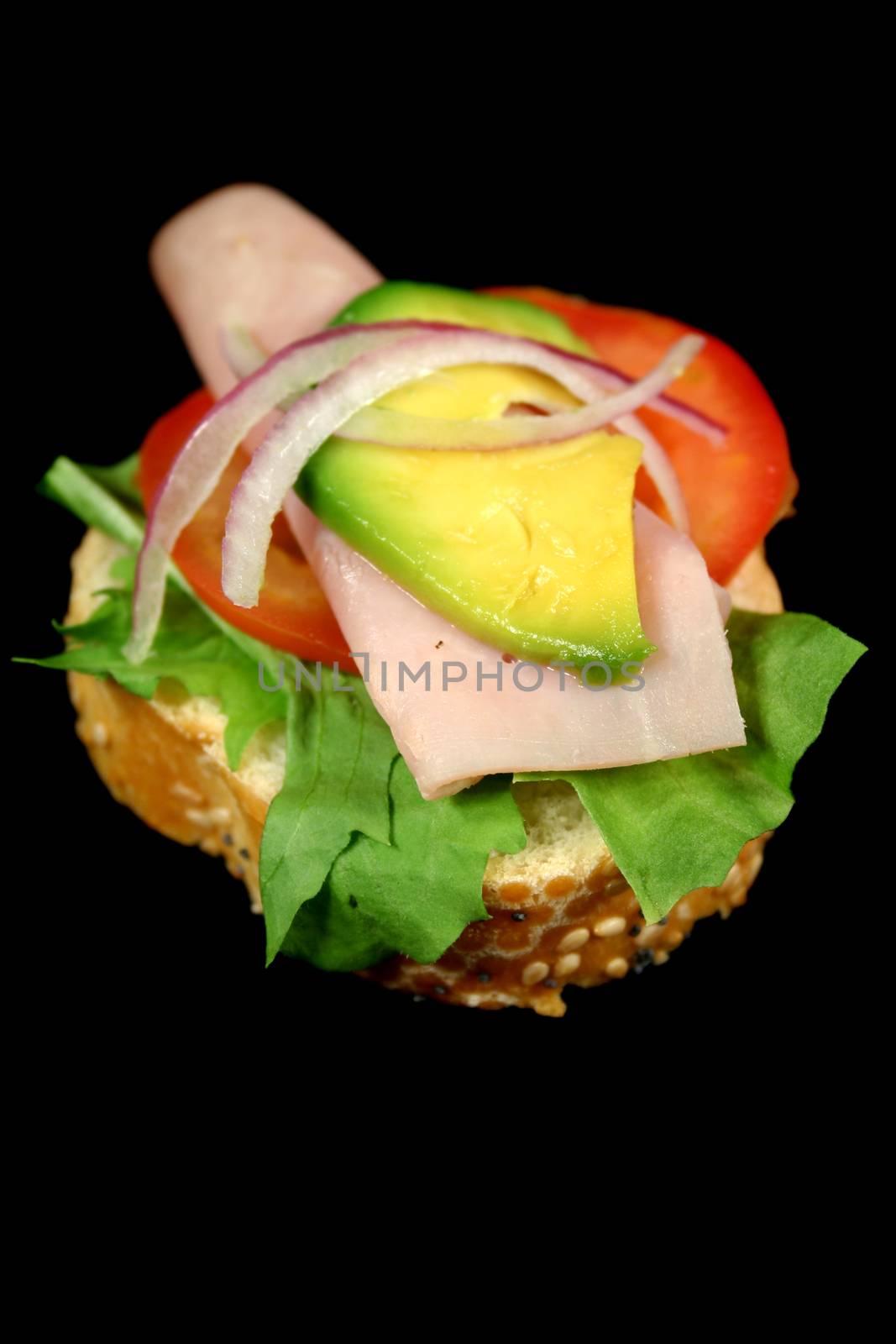 A delightful ham, tomato and avocado bite ready to eat.