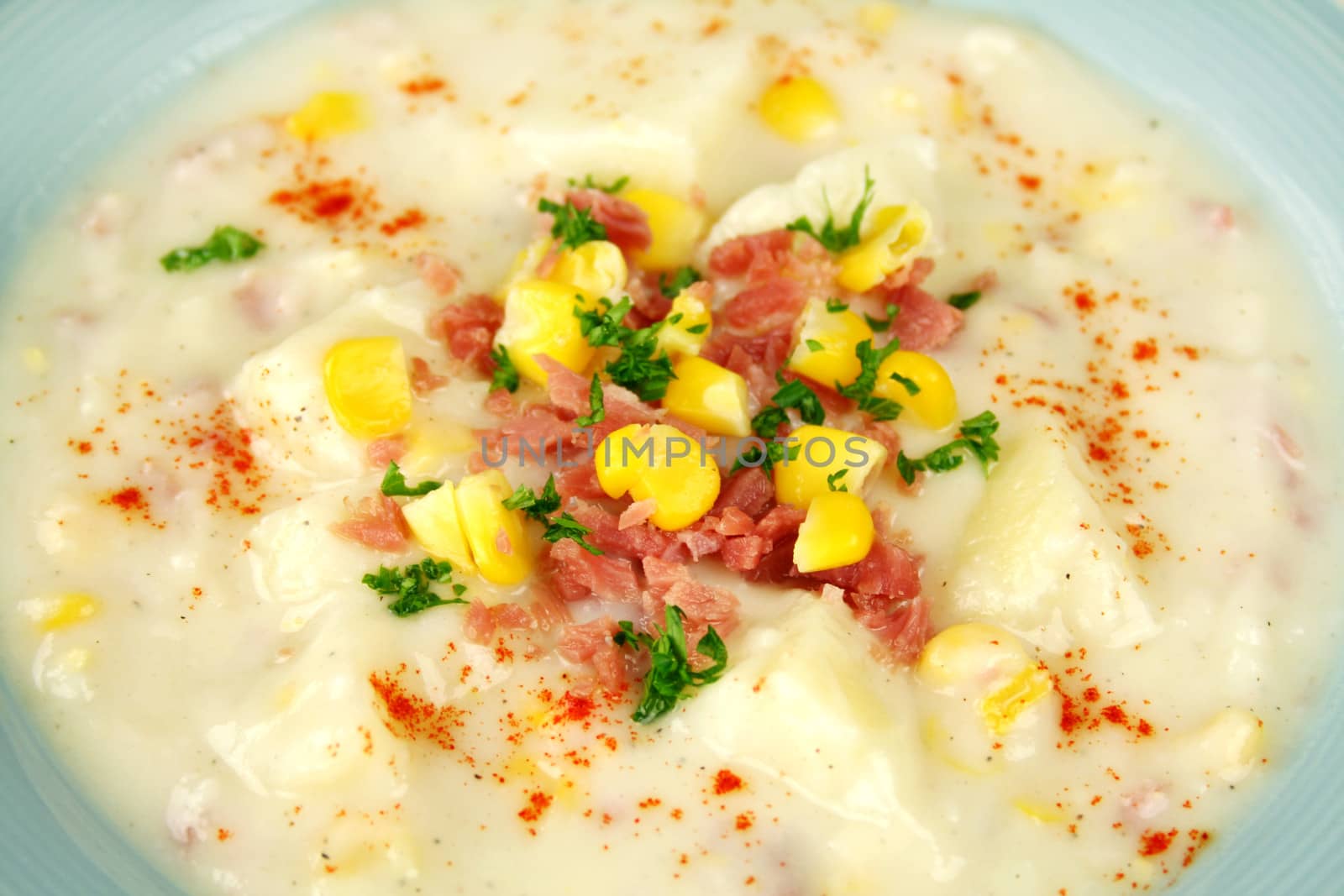 Background of ham corn and potato chowder with paprika ready to serve.