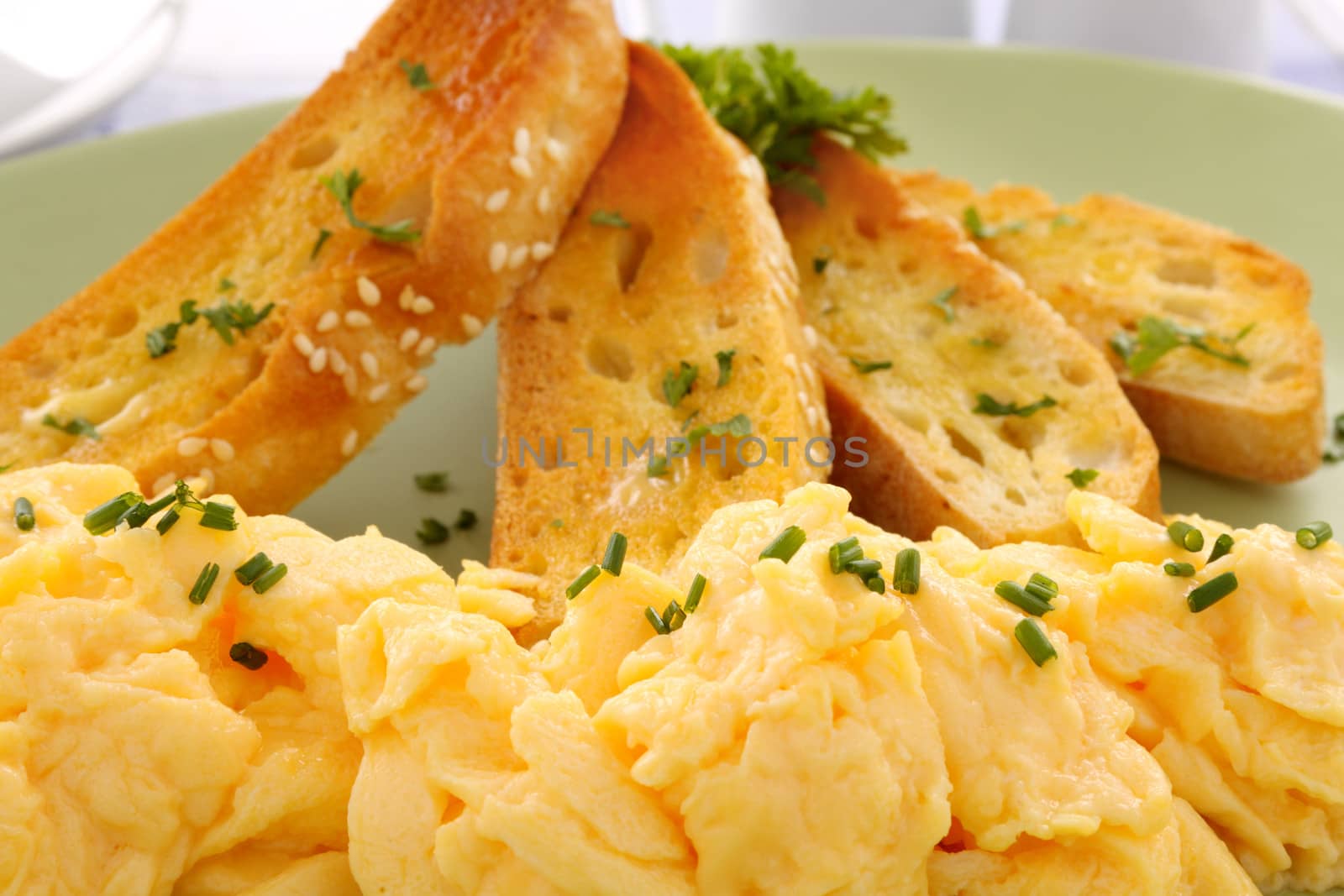 Delicious and healthy breakfast of scrambled eggs with Turkish bread toast.