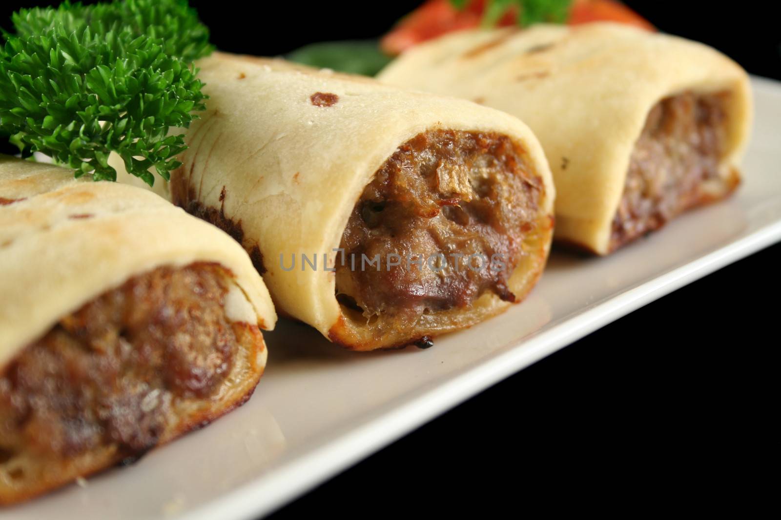 Delicious fresh baked homestyle sausage rolls ready to serve.