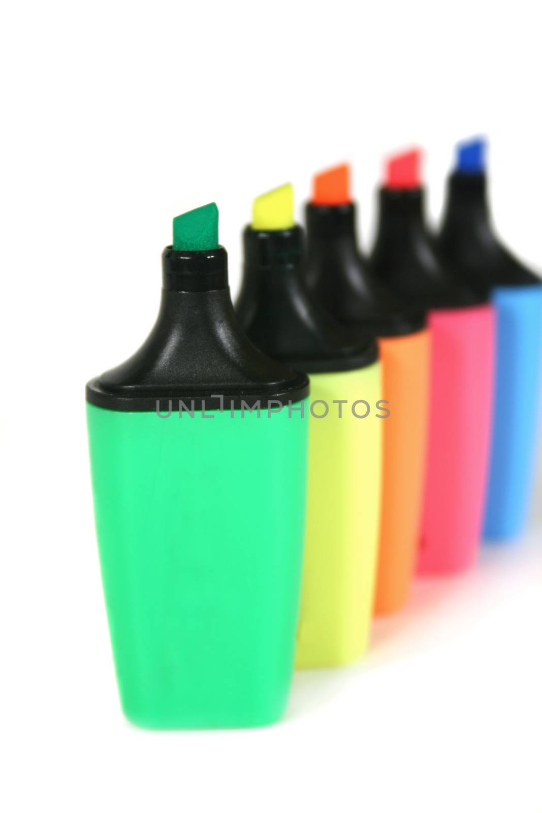 Multi colored highlighter pens in a row.