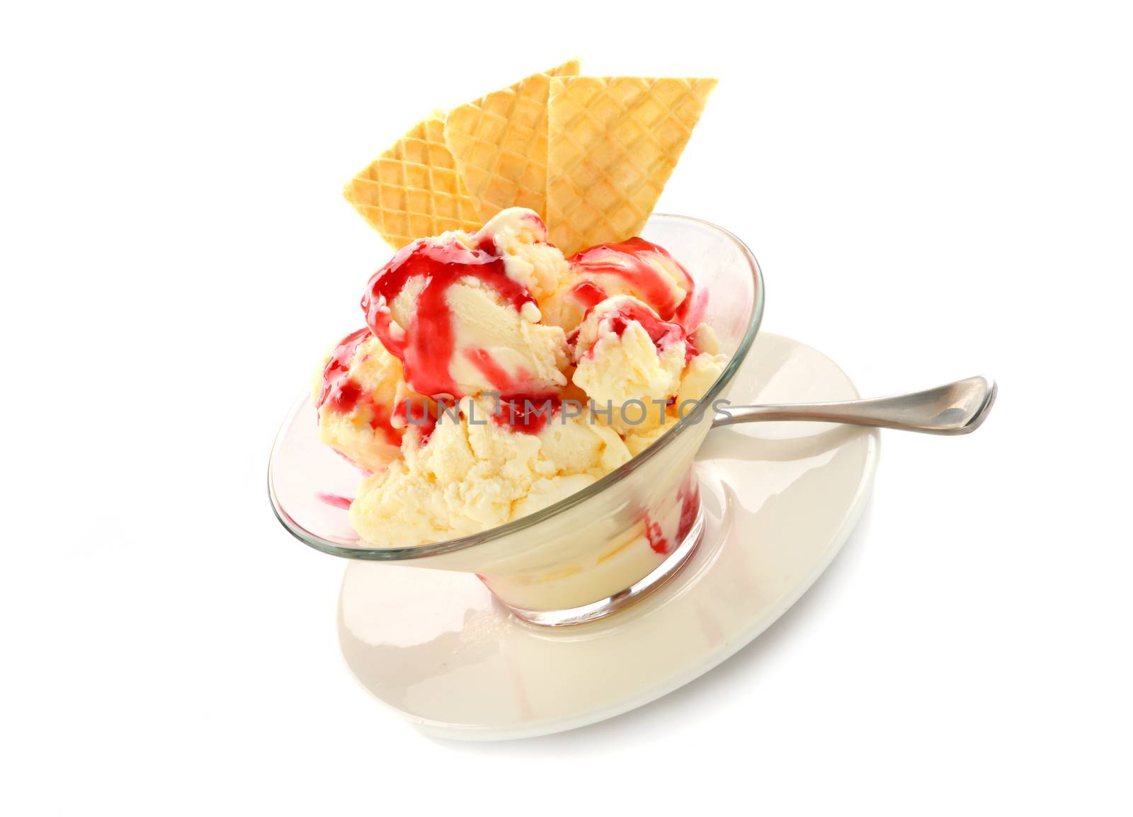 Vanilla ice cream with strawberry topping and golden wafers.