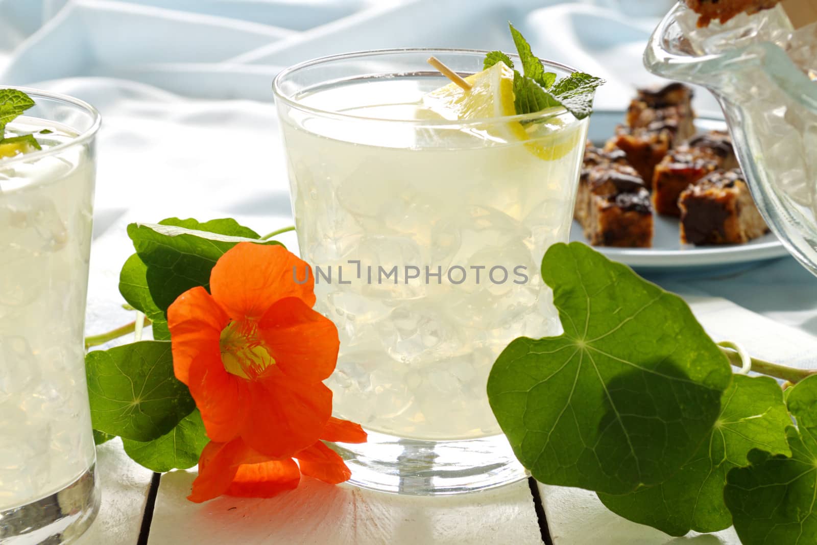 Two ice cold lemon drinks on the picnic table ready to serve.