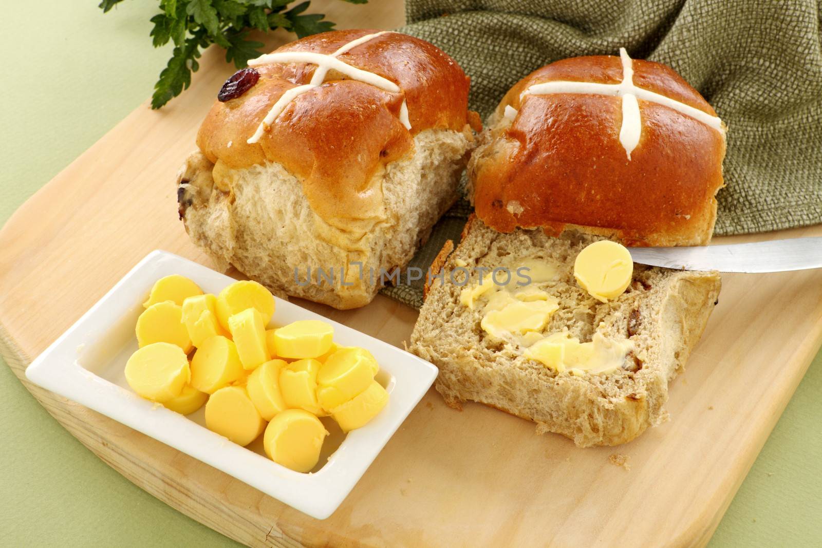 Hot cross buns with butter ready to serve for Easter.