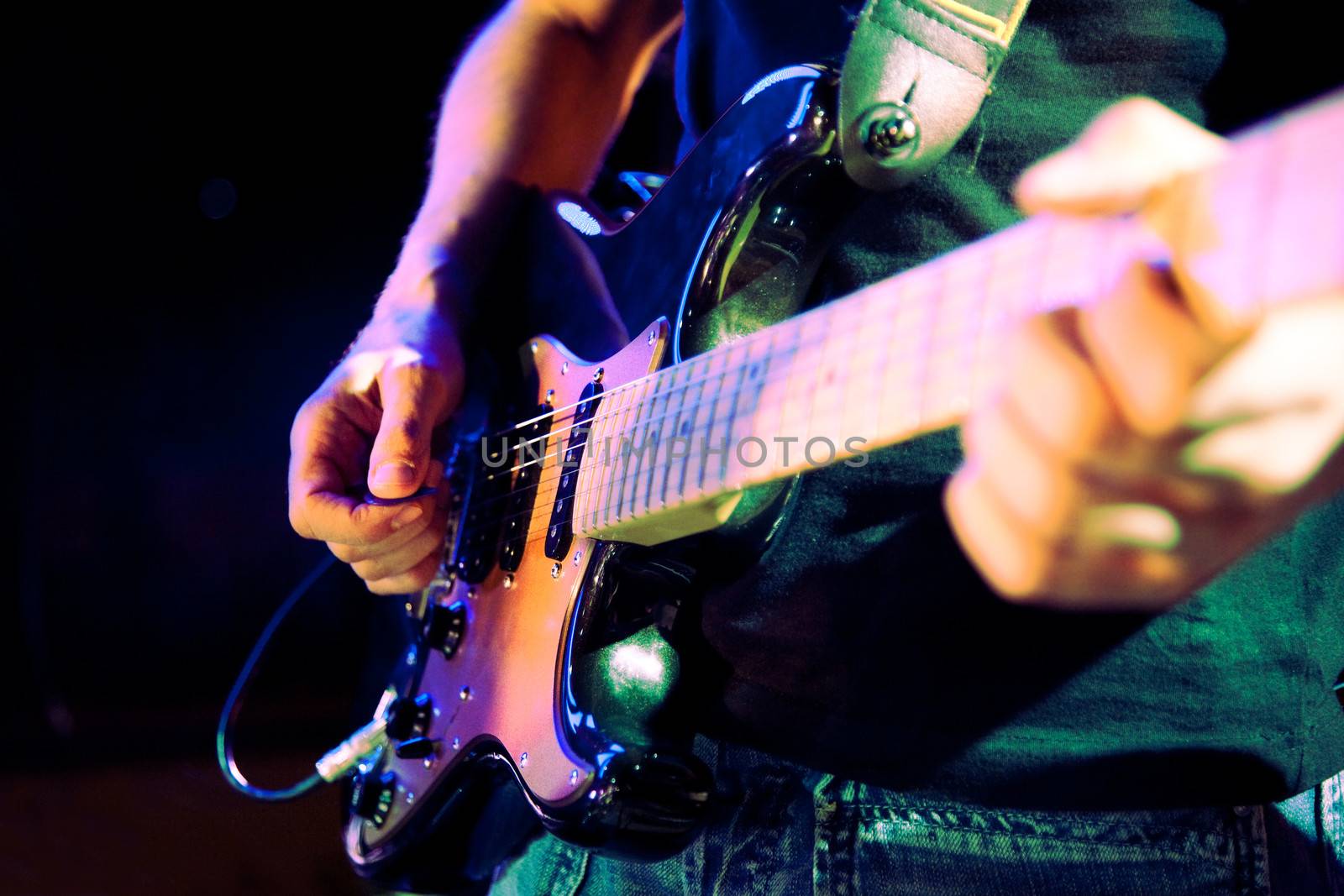 Close up image of guitar player on stage