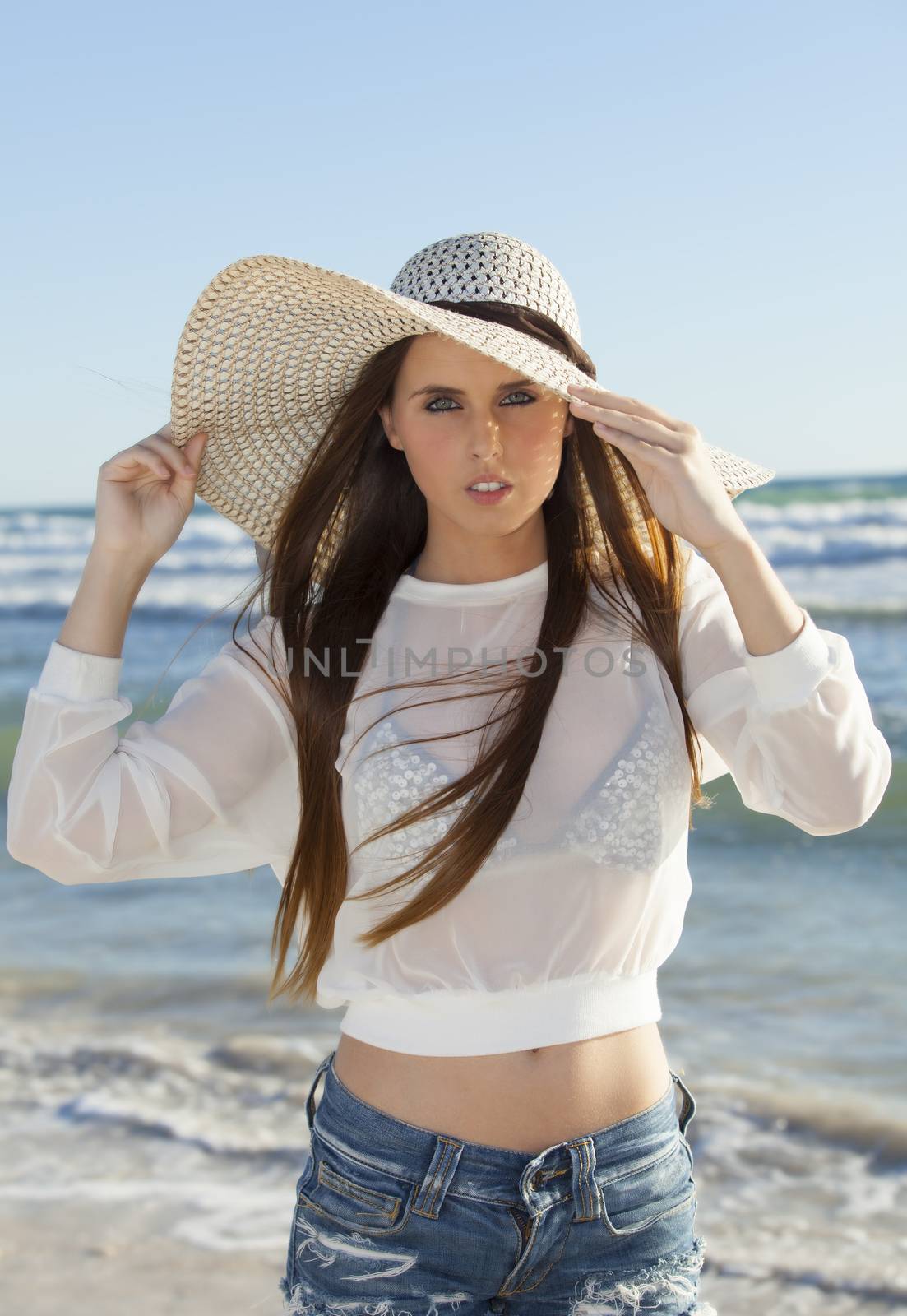 woman on the beach with a hat by bernjuer