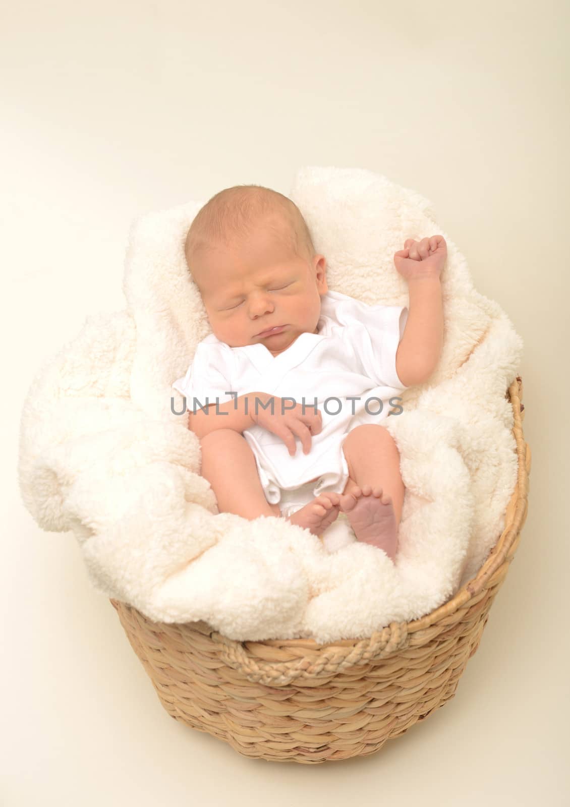 peaceful newborn baby or infant sleeping in basket