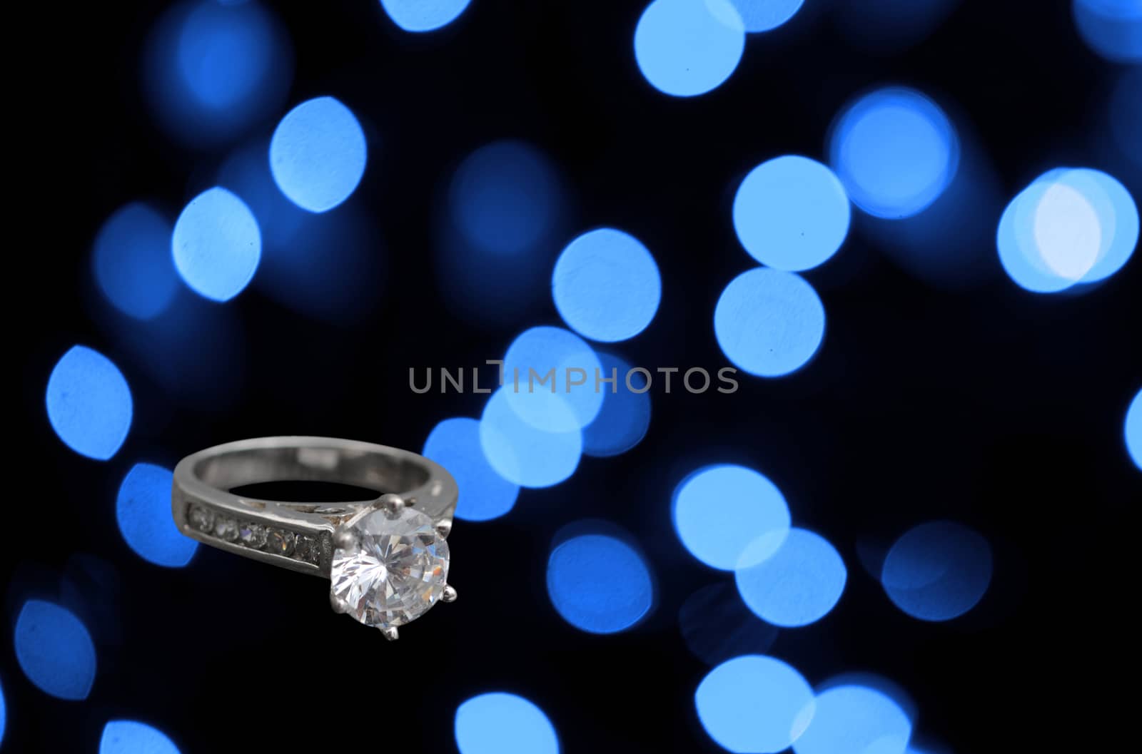 diamond engagement ring on abstract blue background