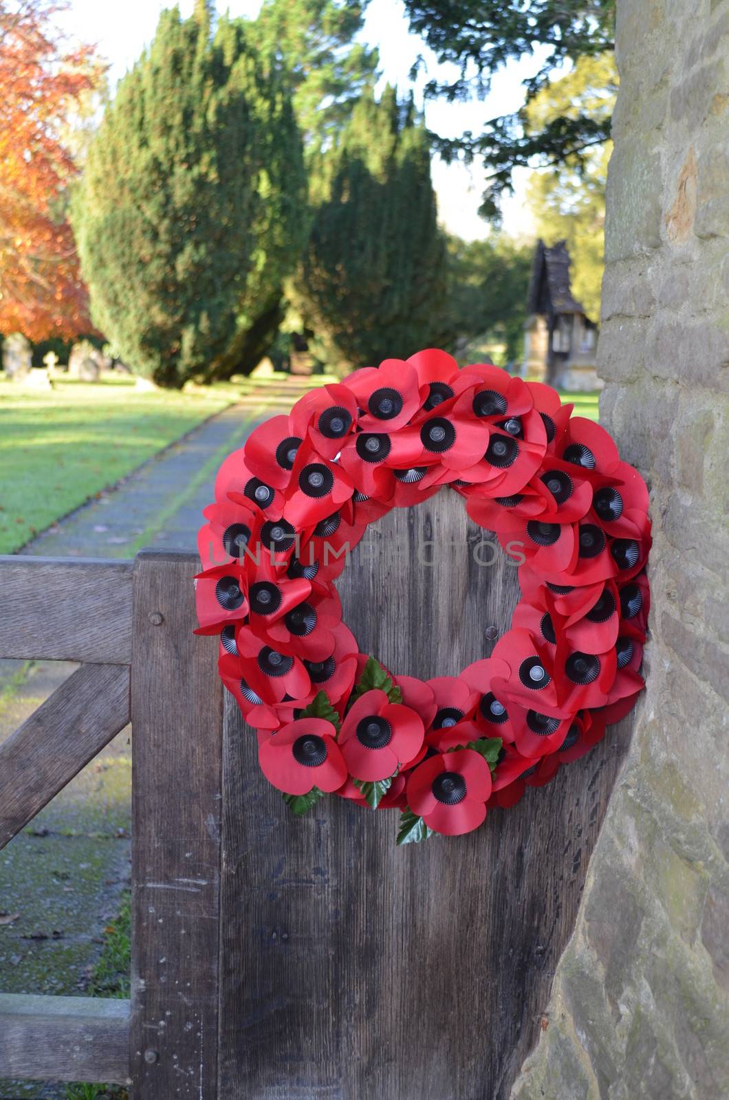 A poppy wreath on the gate entrance to a English church for a Remembrance Sunday service.