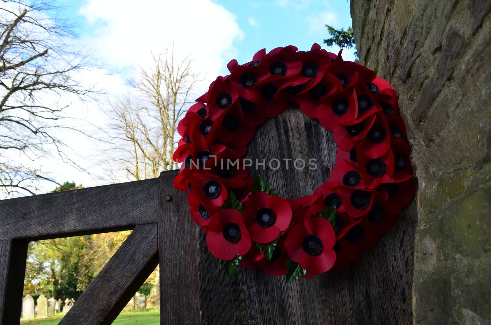 A poppy wreath on a church gate ready for the Remembrance Sunday service.
