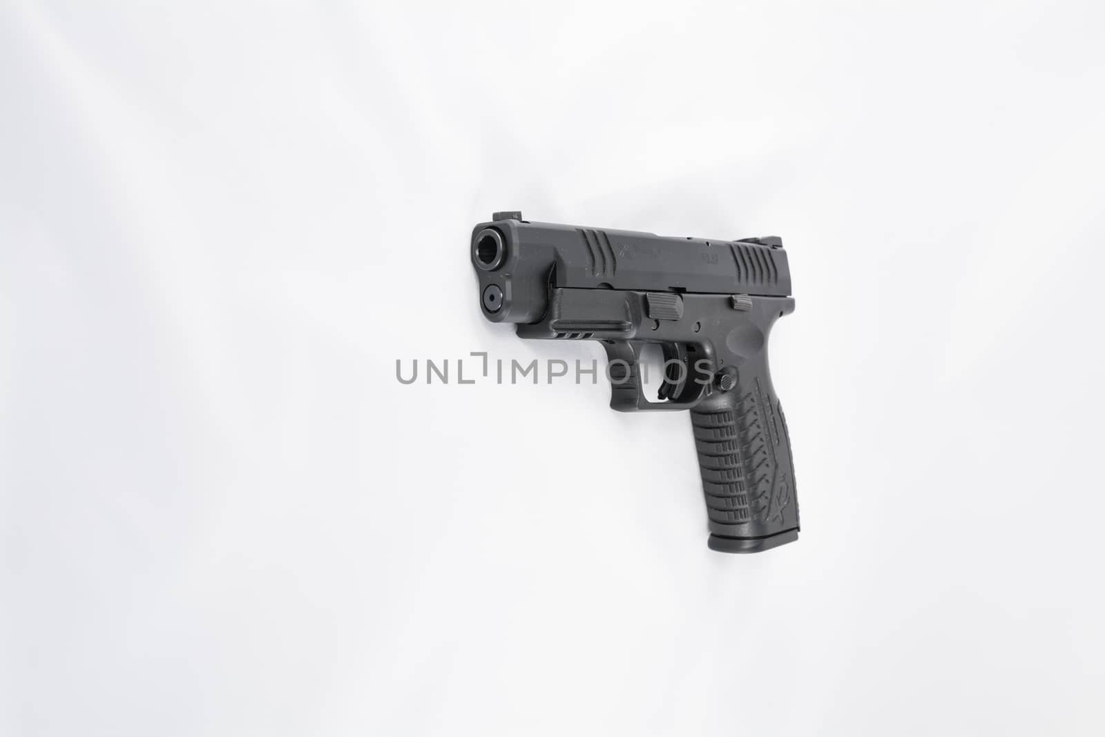 Hand gun on white background by IVYPHOTOS