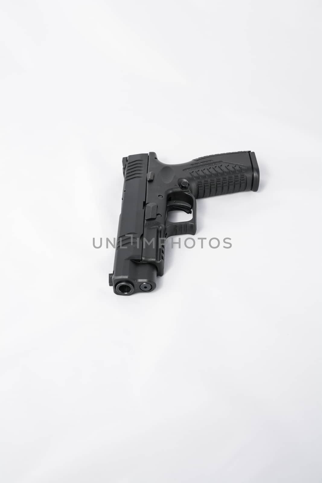 Hand gun on white background by IVYPHOTOS
