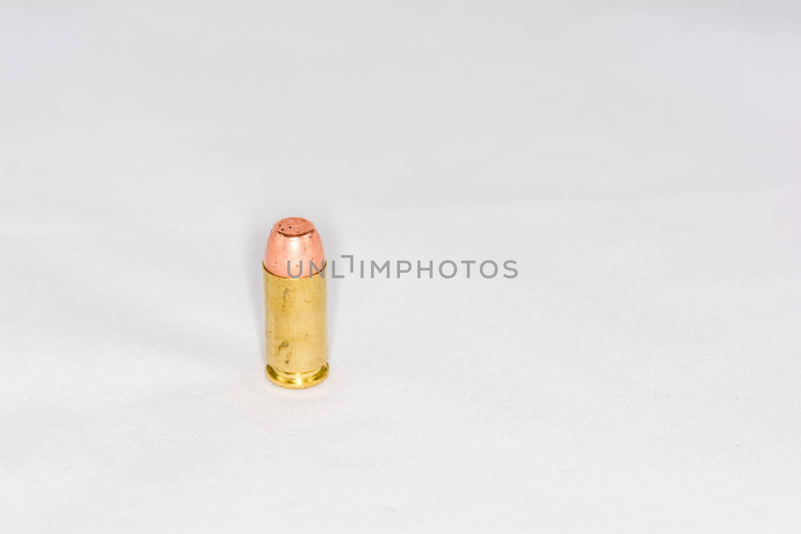 Hand gun bullet on white background with detail