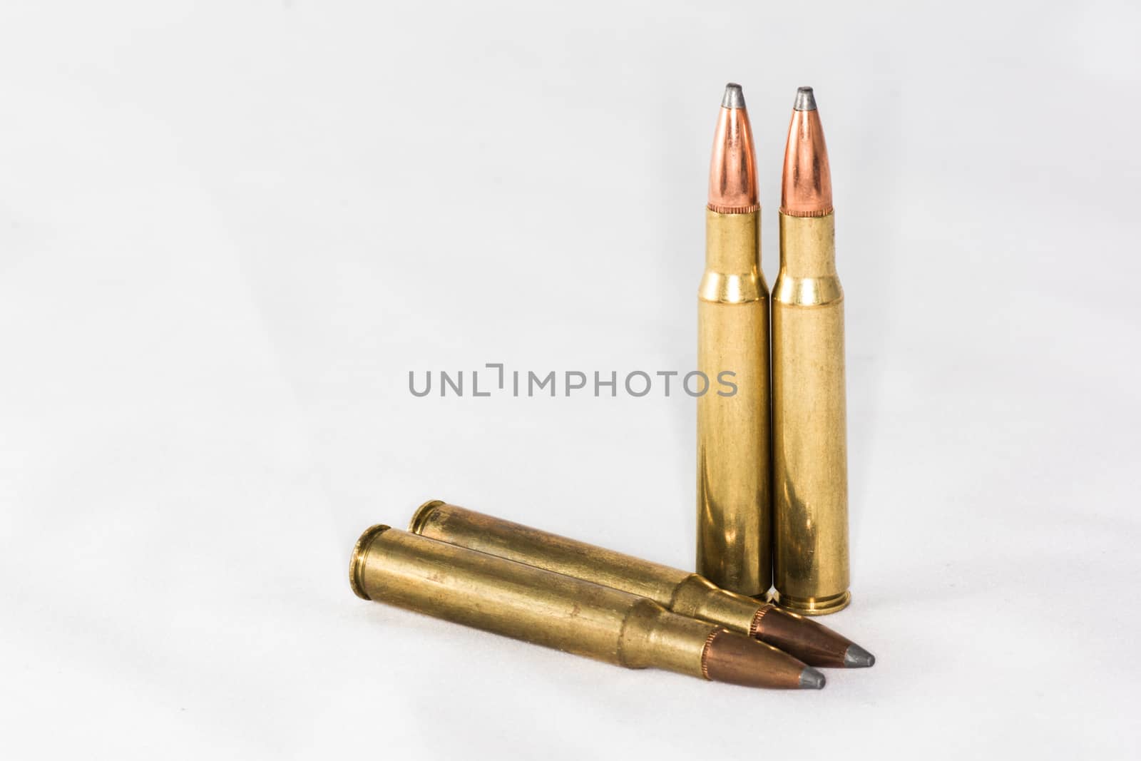 A few rifle bullets on white background with details