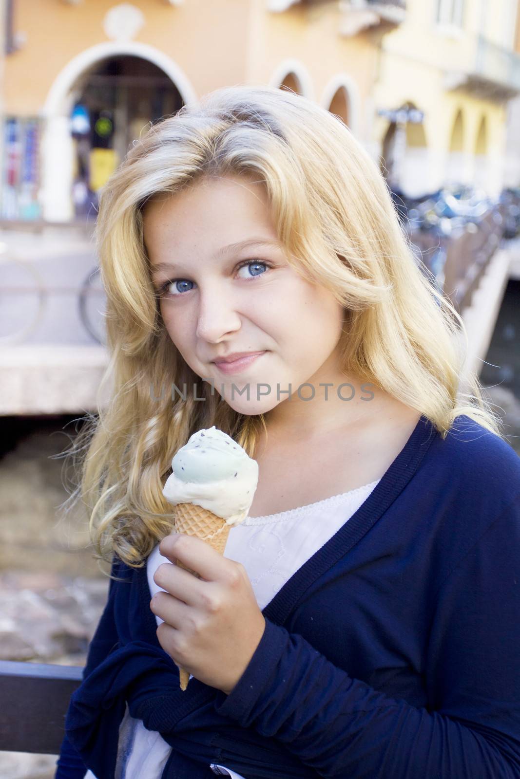 A beautiful blond teenager having an icecream