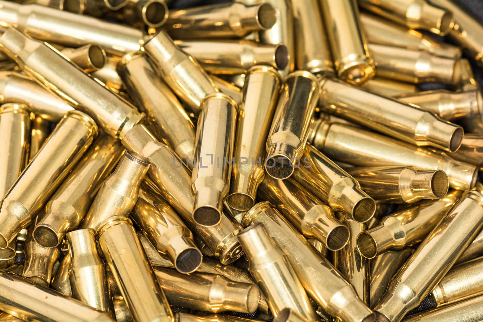 Pile of empty bullet shells by IVYPHOTOS