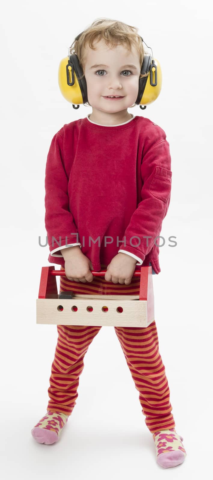 child in red clothing with toolbox and earmuffs. vertical image