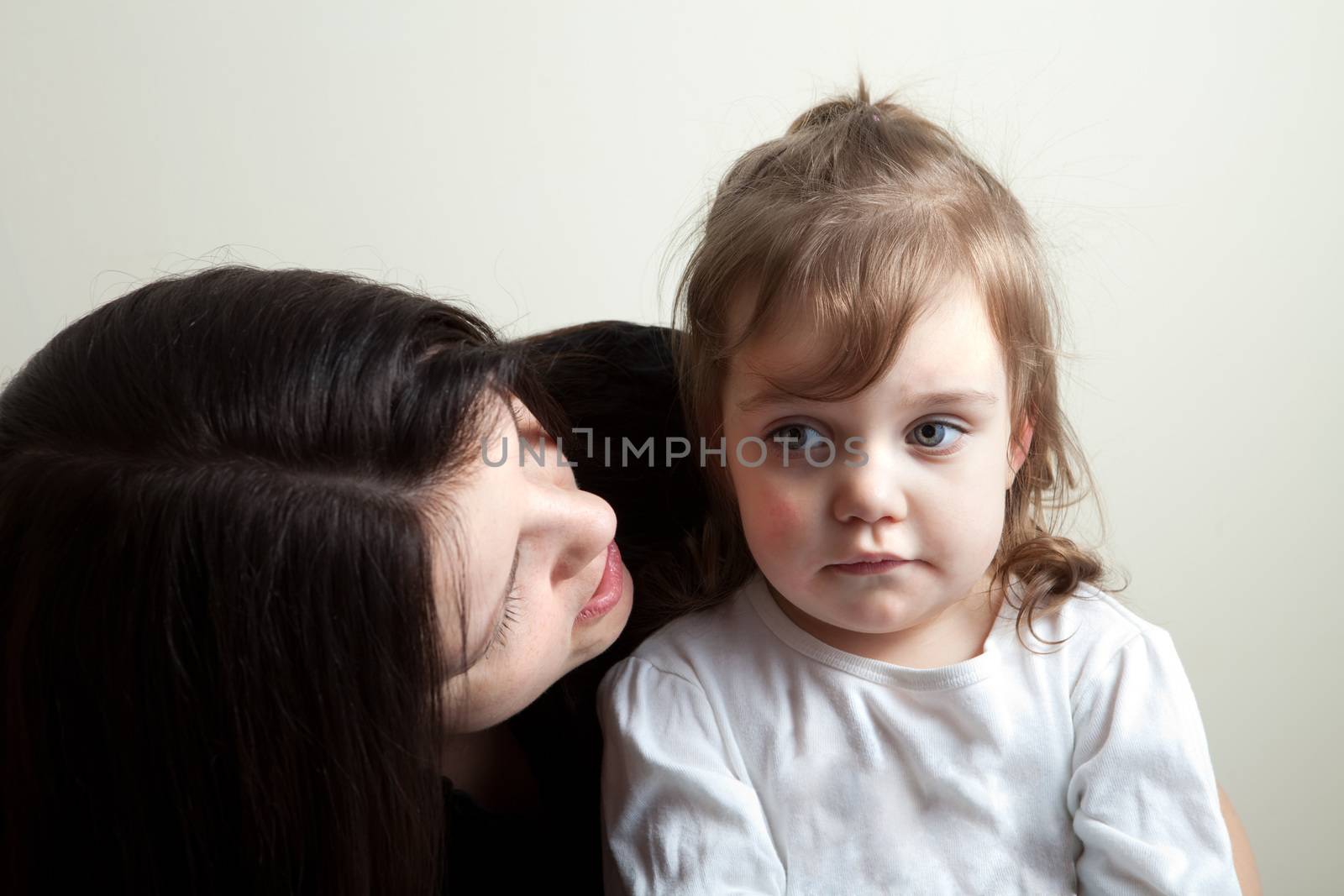 Toddler age girl getting spoken to by her mother. Great parenting concept image.
