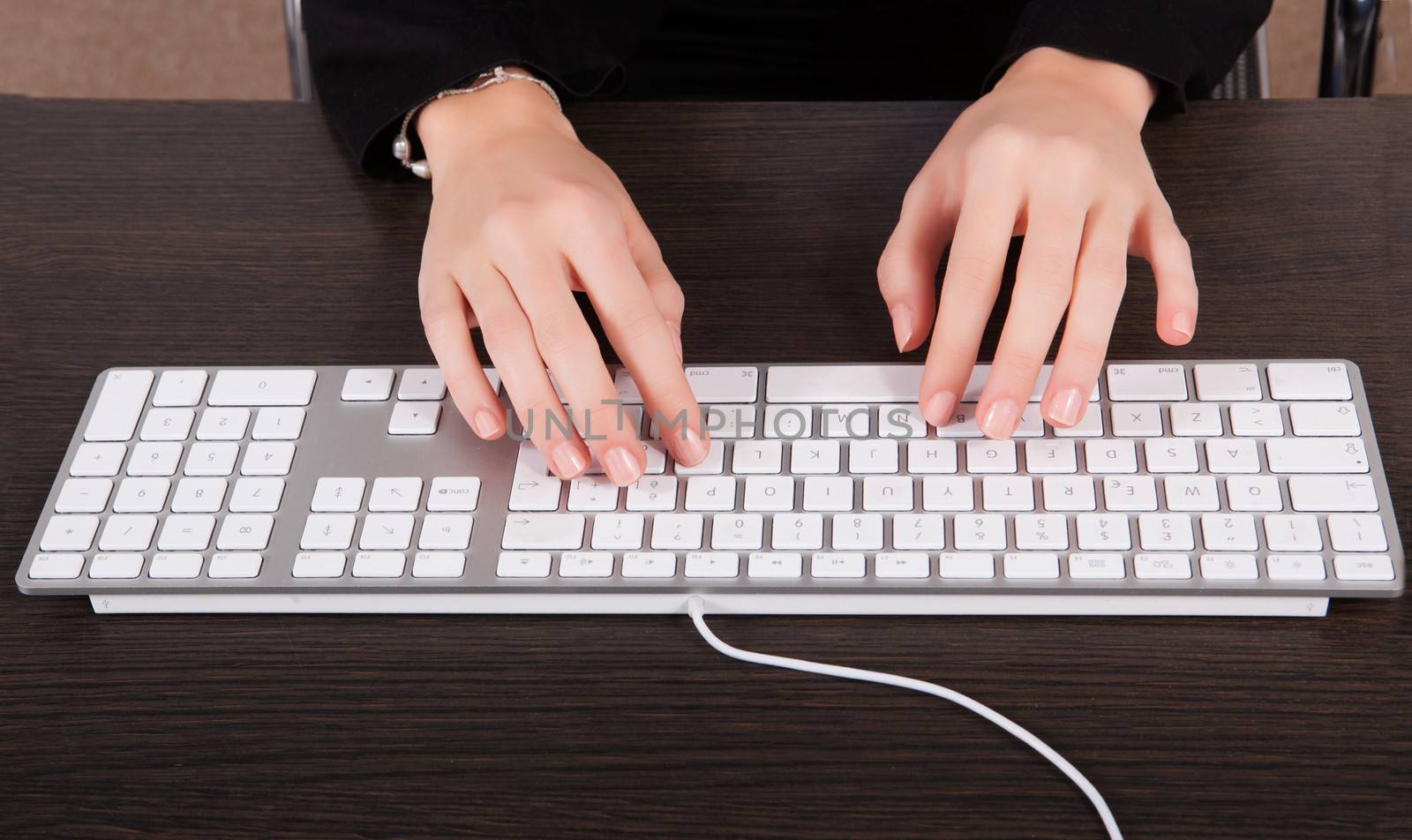 Businesswoman using keyboard by matteobragaglio