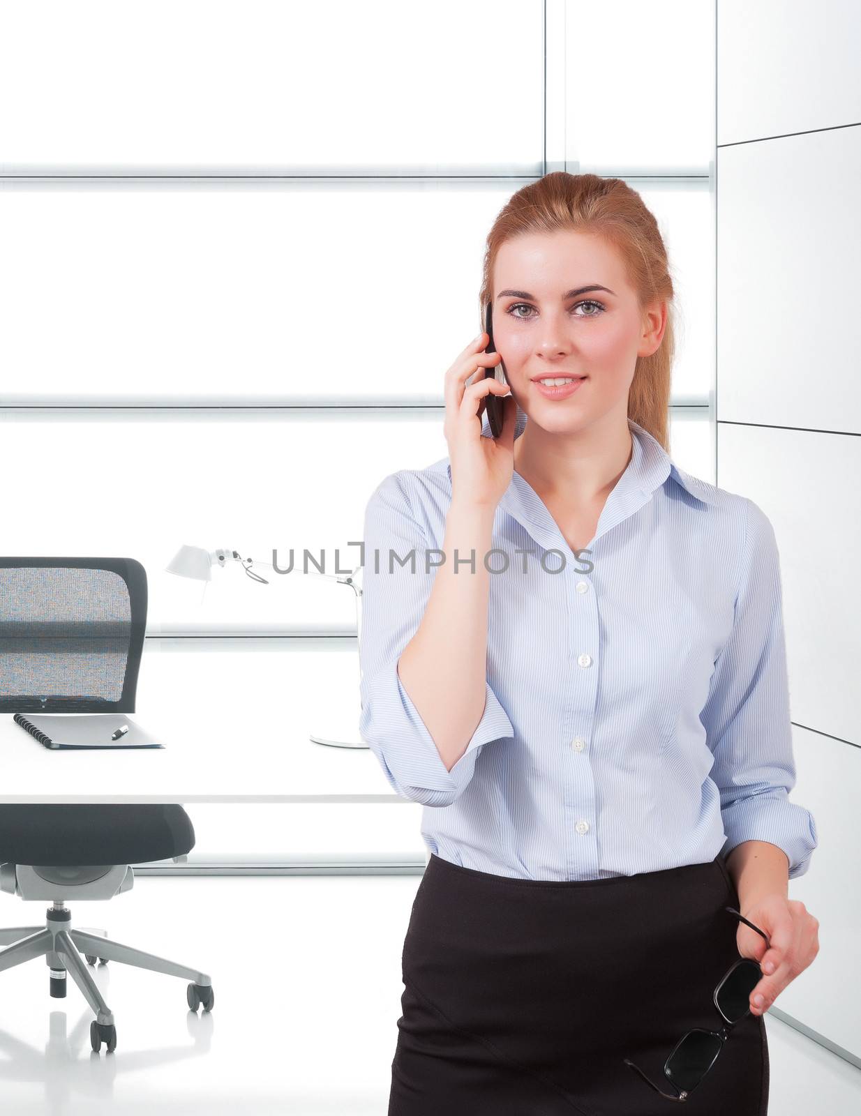 businesswoman using phone by matteobragaglio